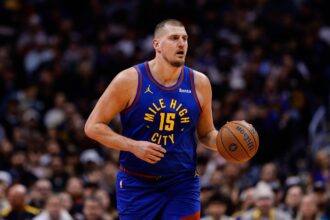 Denver, Colorado, USA; Denver Nuggets center Nikola Jokic (15) controls the ball in the first quarter against the San Antonio Spurs at Ball Arena. Mandatory Credit: Isaiah J. Downing-Imagn Images