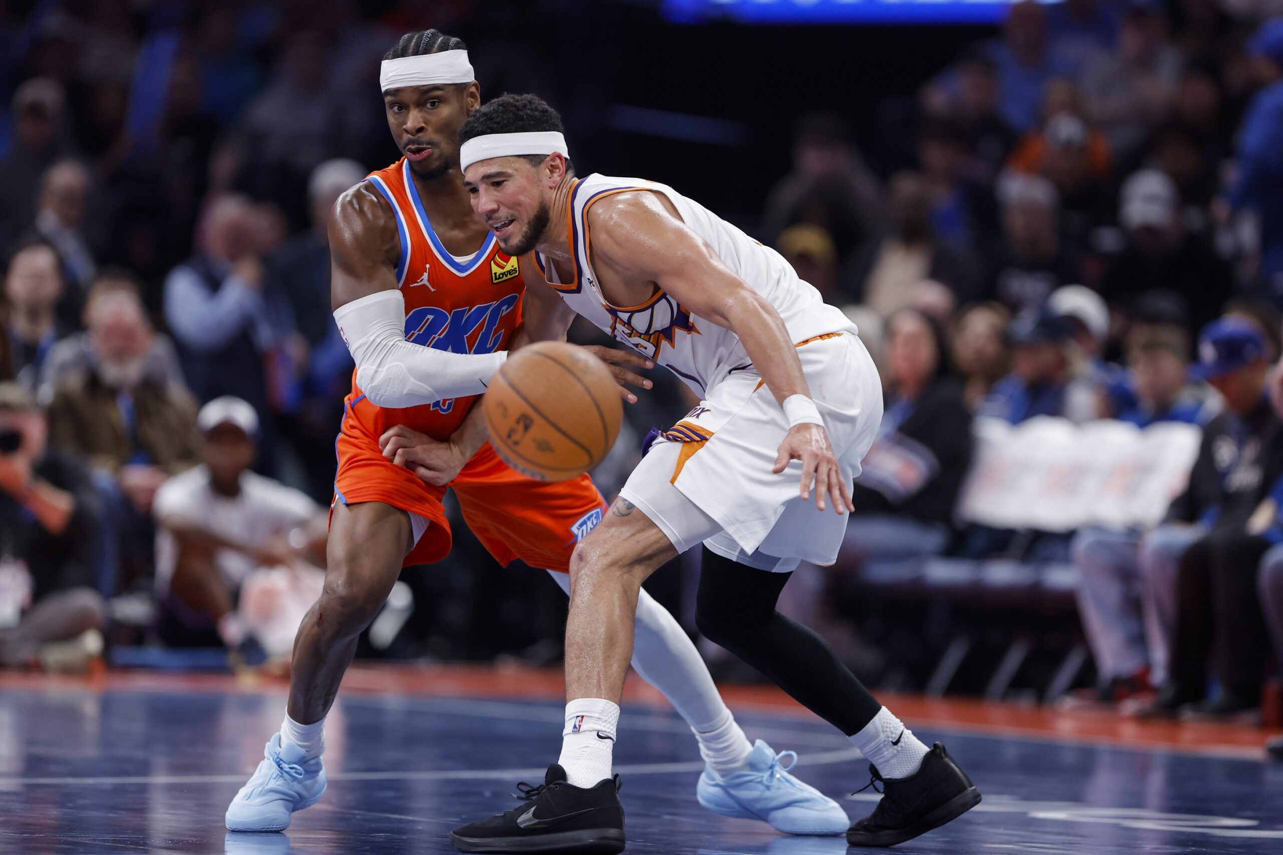 Nov 28, 2025; Oklahoma City, Oklahoma, USA;Oklahoma City Thunder guard Shai Gilgeous-Alexander (2) forces Phoenix Suns guard Devin Booker (1) to turn over the ball during the second half at Paycom Center. Mandatory Credit: Alonzo Adams-Imagn Images