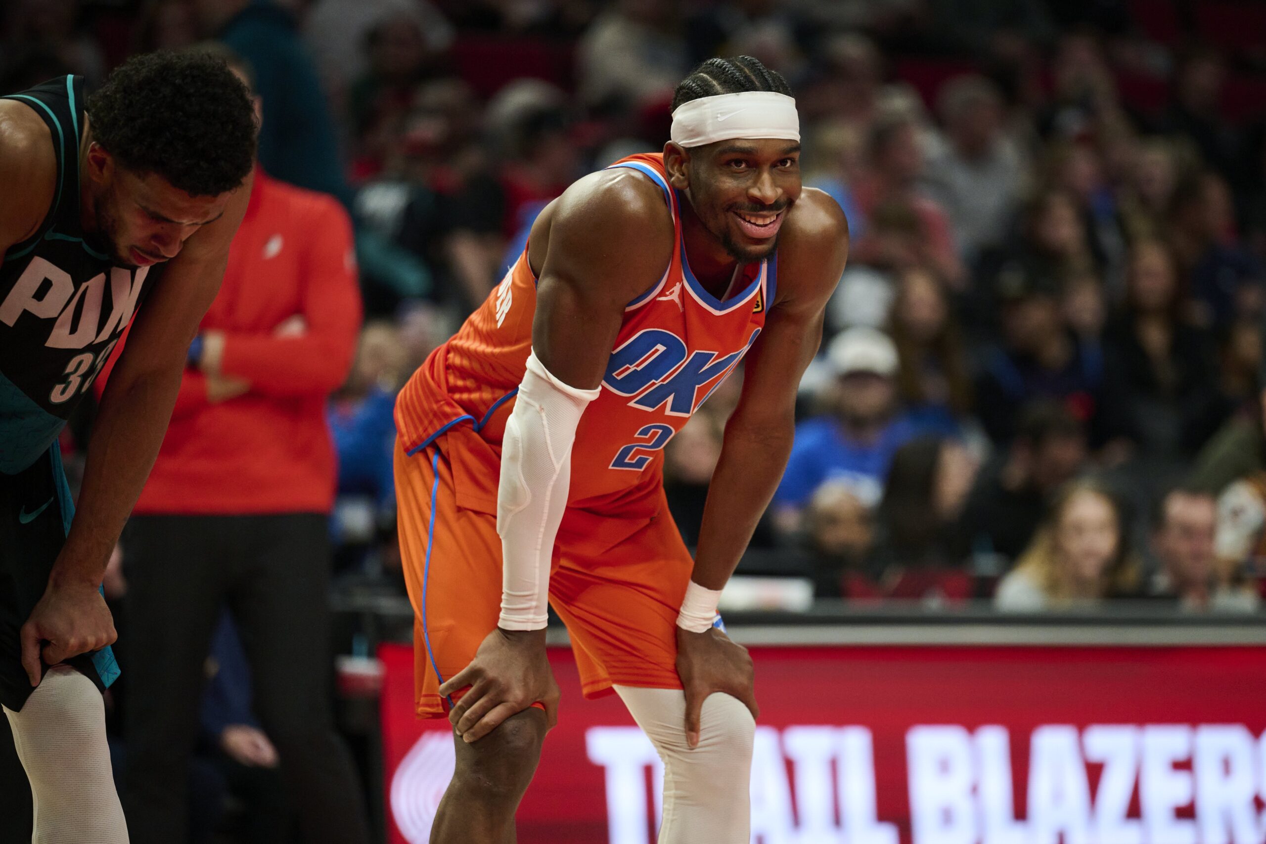 Nov 30, 2025; Portland, Oregon, USA; Oklahoma City Thunder guard Shai Gilgeous-Alexander (2) smiles at a fan during the second half in a game against the Portland Trail Blazers at Moda Center. Mandatory Credit: Troy Wayrynen-Imagn Images