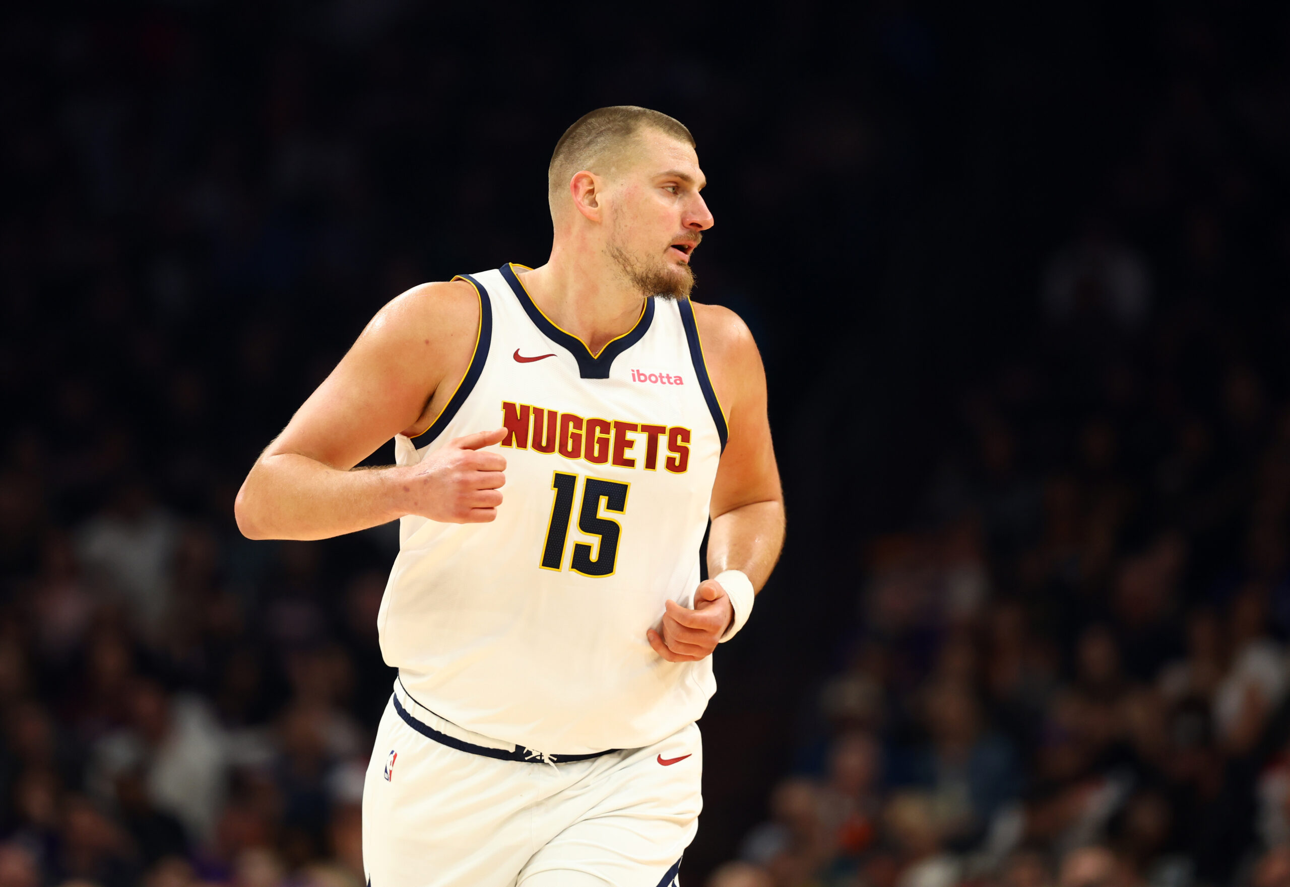 Nov 29, 2025; Phoenix, Arizona, USA; Denver Nuggets center Nikola Jokic (15) against the Phoenix Suns at the Mortgage Matchup Center. Mandatory Credit: Mark J. Rebilas-Imagn Images