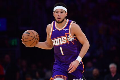 Los Angeles, California, USA; Phoenix Suns guard Devin Booker (1) moves the ball up court against the Los Angeles Lakers during the first half at Crypto.com Arena. Mandatory Credit: Gary A. Vasquez-Imagn Images