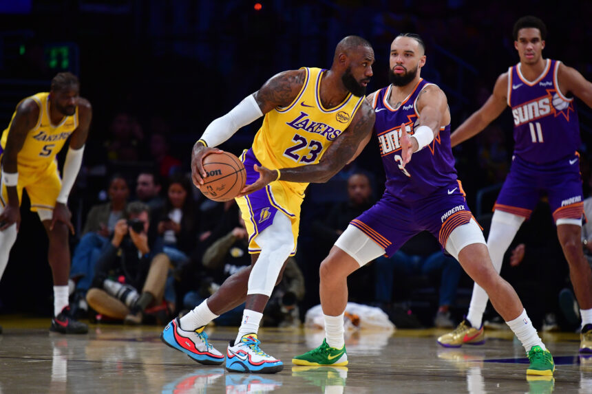 Dec 1, 2025; Los Angeles, California, USA; Los Angeles Lakers forward LeBron James (23) moves the ball against Phoenix Suns forward Dillon Brooks (3) during the first half at Crypto.com Arena. Mandatory Credit: Gary A. Vasquez-Imagn Images