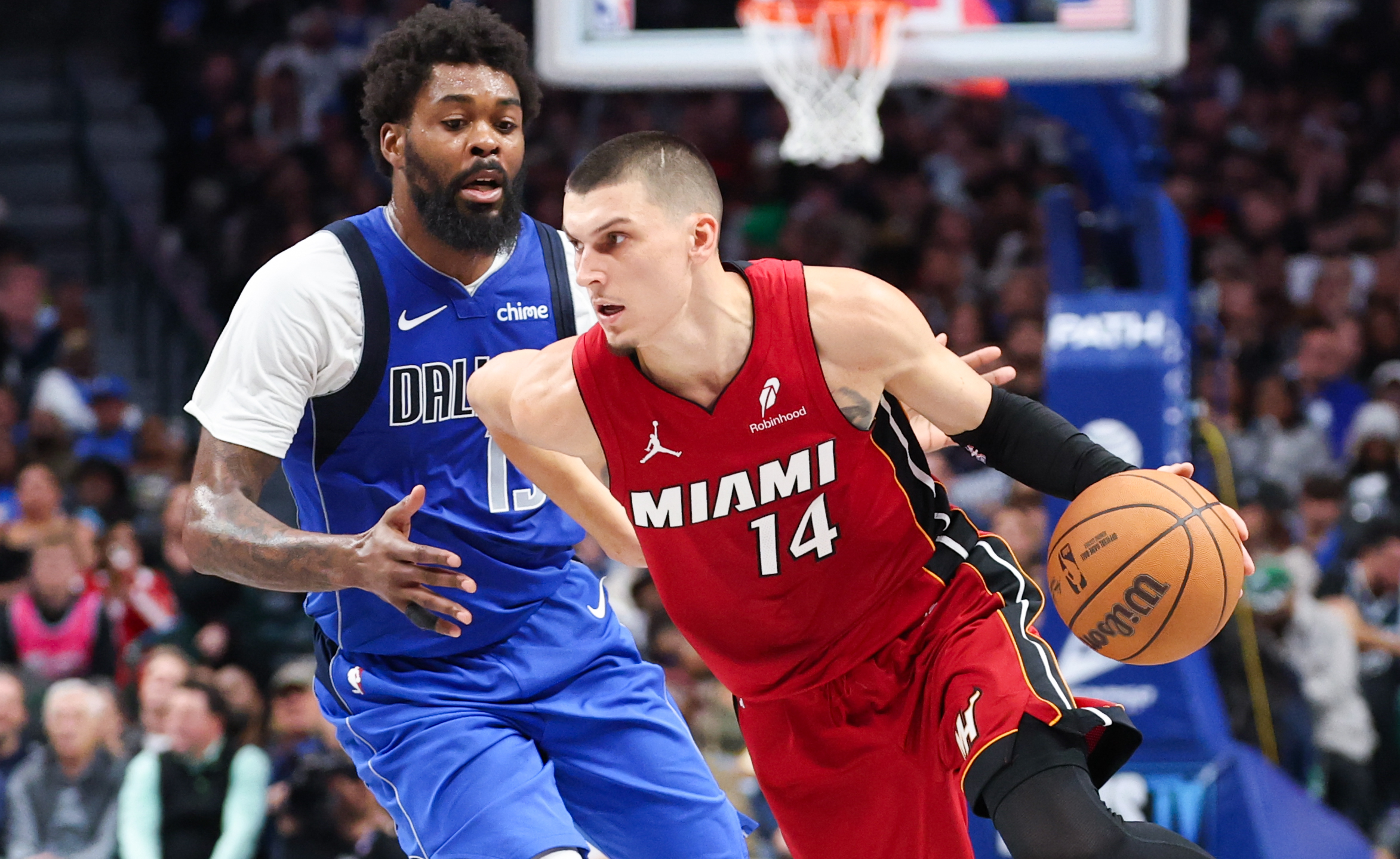 Dec 3, 2025; Dallas, Texas, USA; Miami Heat guard Tyler Herro (14) dribbles as Dallas Mavericks forward Naji Marshall (13) defends during the second half at American Airlines Center. Mandatory Credit: Kevin Jairaj-Imagn Images
