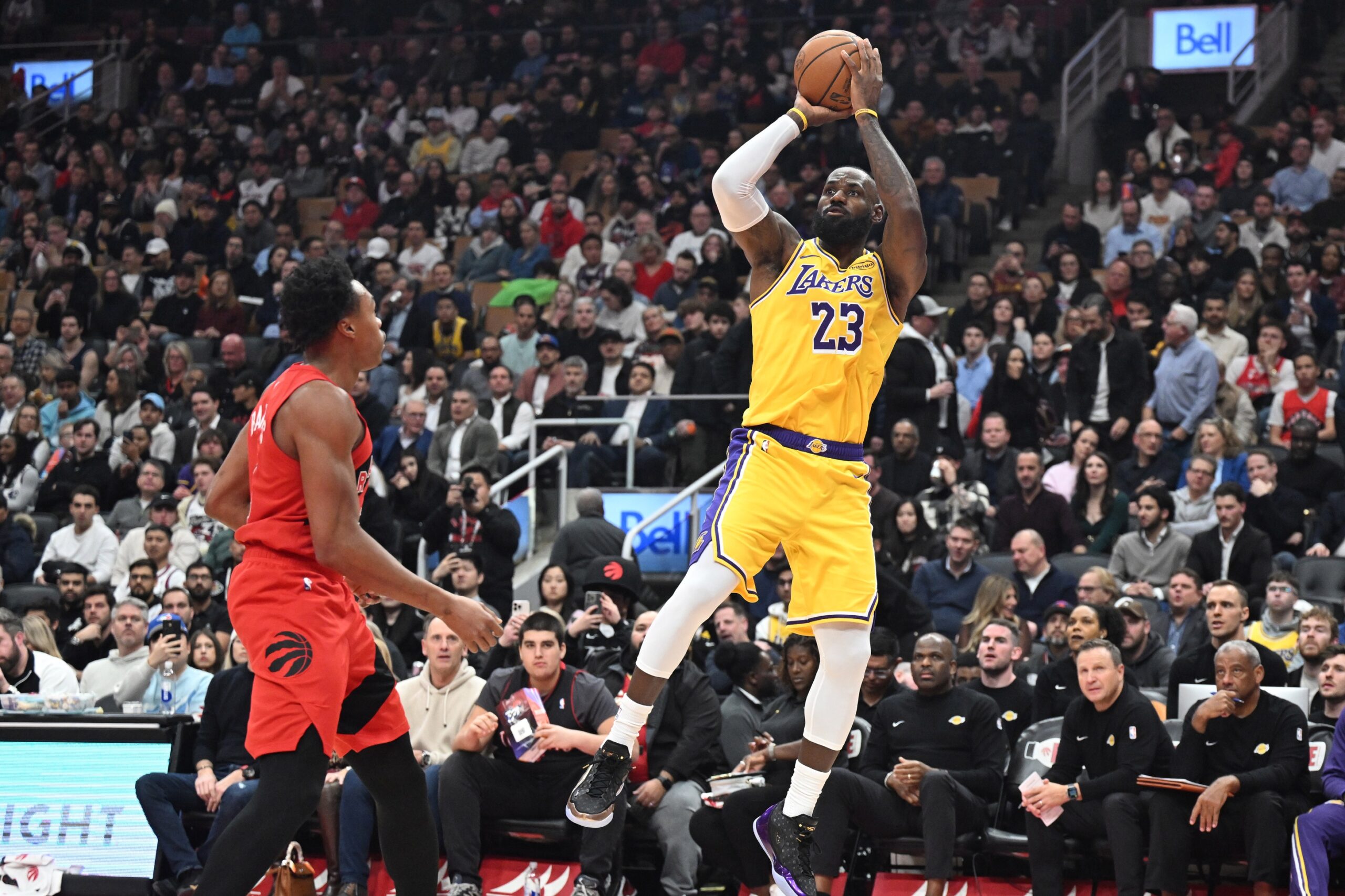 Dec 4, 2025; Toronto, Ontario, CAN; Los Angeles Lakers forward LeBron James (23) shoots the ball over Toronto Raptors forward Scottie Barnes (4) in the first half at Scotiabank Arena. Mandatory Credit: Dan Hamilton-Imagn Images