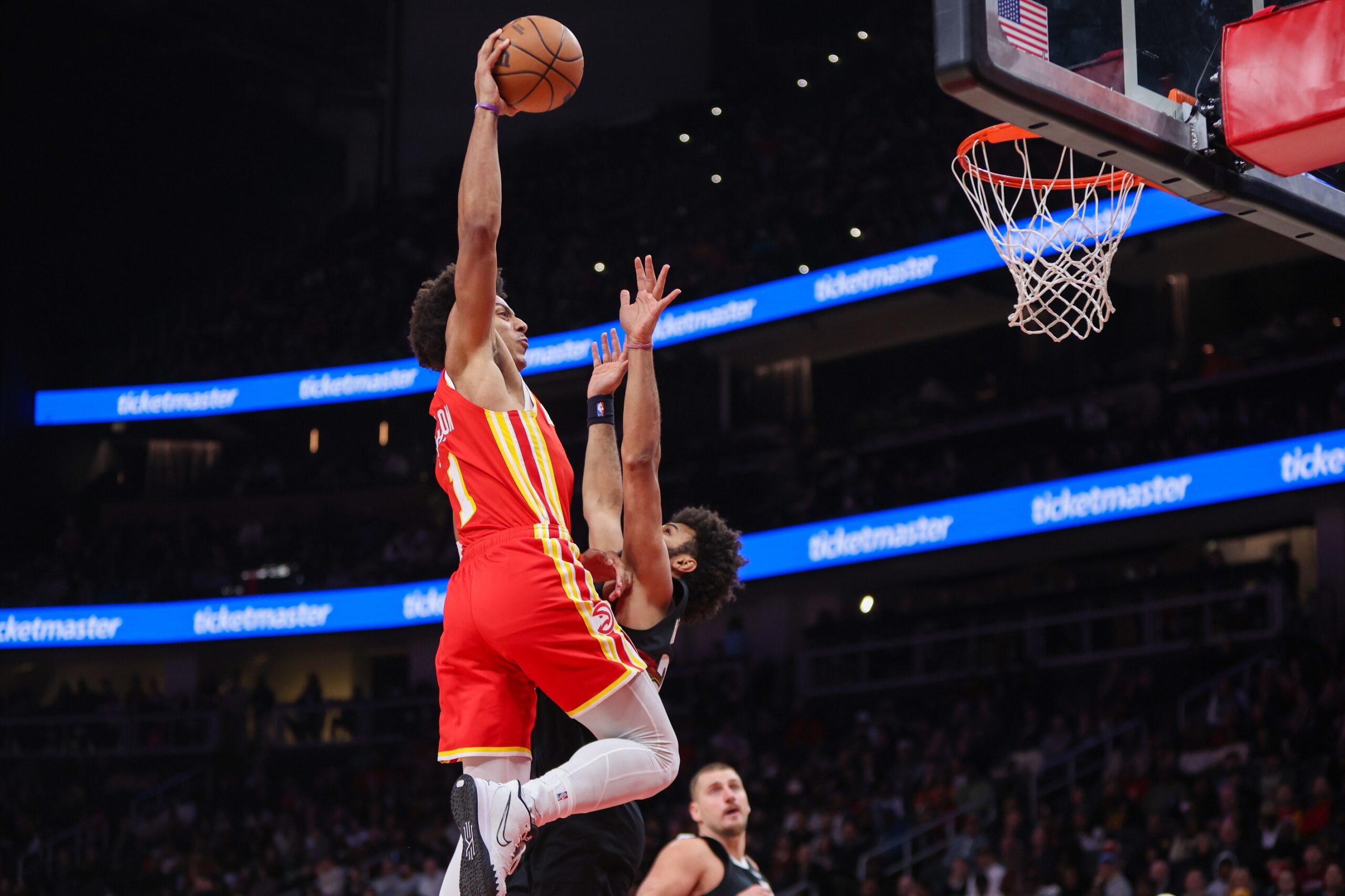 Dec 5, 2025; Atlanta, Georgia, USA; Atlanta Hawks forward Jalen Johnson (1) dunks over Denver Nuggets guard Jamal Murray (27) in the second quarter at State Farm Arena. Mandatory Credit: Brett Davis-Imagn Images
