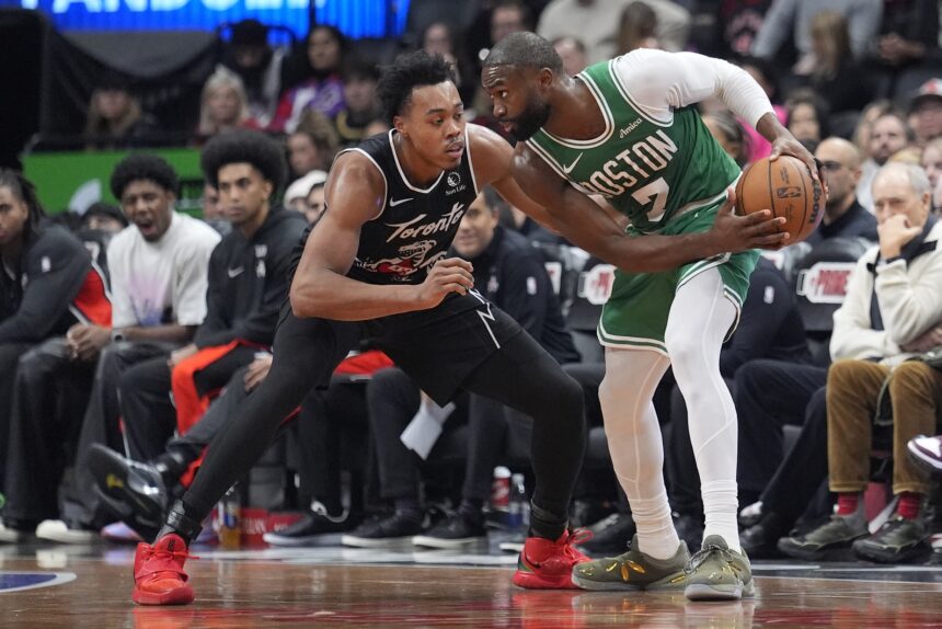 Dec 7, 2025; Toronto, Ontario, CAN; Boston Celtics forward Jaylen Brown (7) controls the ball against Toronto Raptors guard Scottie Barnes (4) during the second half at Scotiabank Arena. Mandatory Credit: John E. Sokolowski-Imagn Images