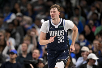 Dallas, Texas, USA; Dallas Mavericks forward Cooper Flagg (32) runs back up the court during the second half against the Brooklyn Nets at the American Airlines Center. Mandatory Credit: Jerome Miron-Imagn Images