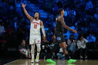 Dec 13, 2025; Las Vegas, Nevada, USA; New York Knicks guard Jalen Brunson (11) reacts as Orlando Magic forward Paolo Banchero (5) walks away during the third quarter at T-Mobile Arena. Mandatory Credit: Kirby Lee-Imagn Images