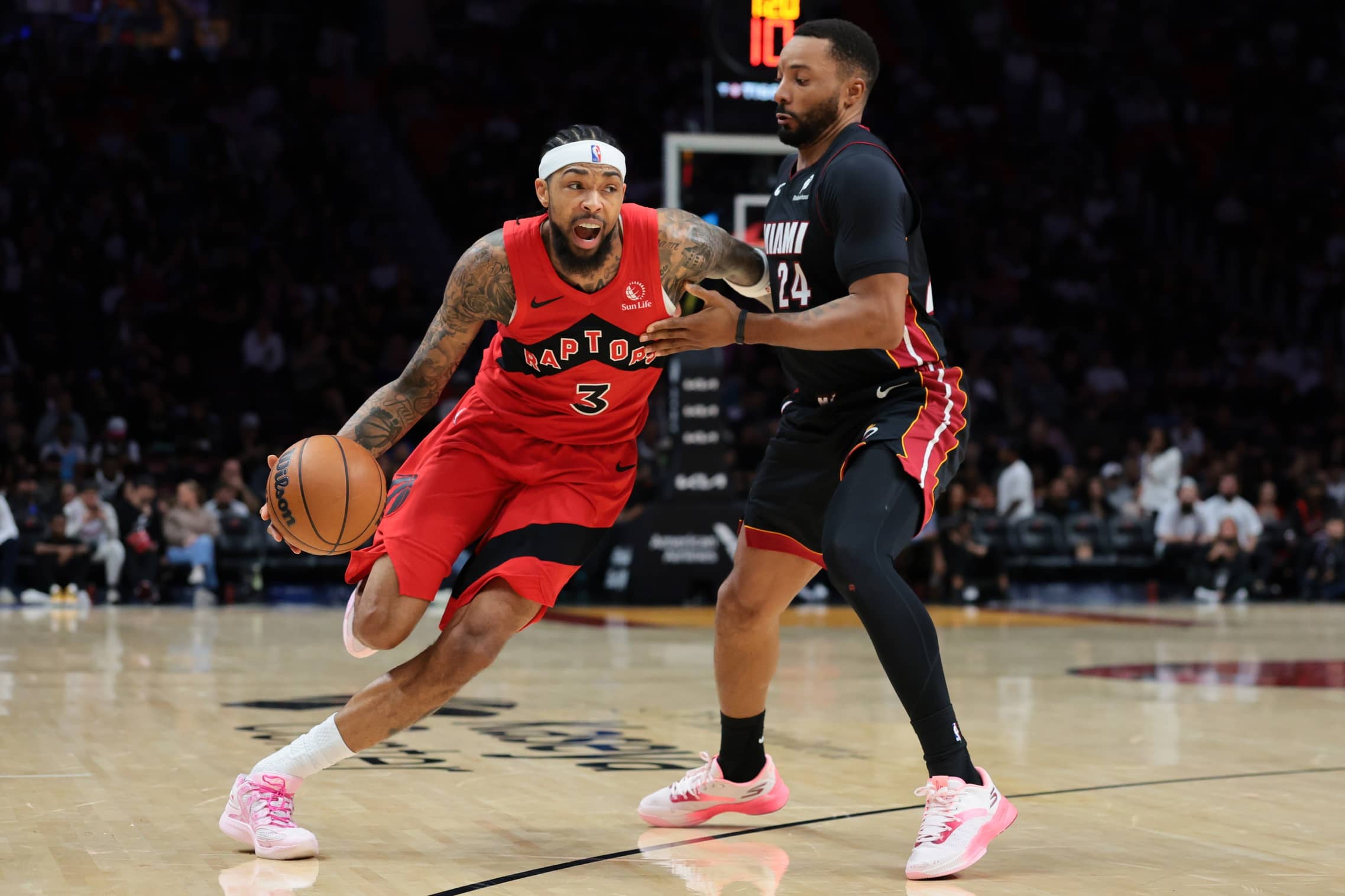 Dec 15, 2025; Miami, Florida, USA; Toronto Raptors forward Brandon Ingram (3) drives to the basket against Miami Heat guard Norman Powell (24) during the second quarter at Kaseya Center. Mandatory Credit: Sam Navarro-Imagn Images