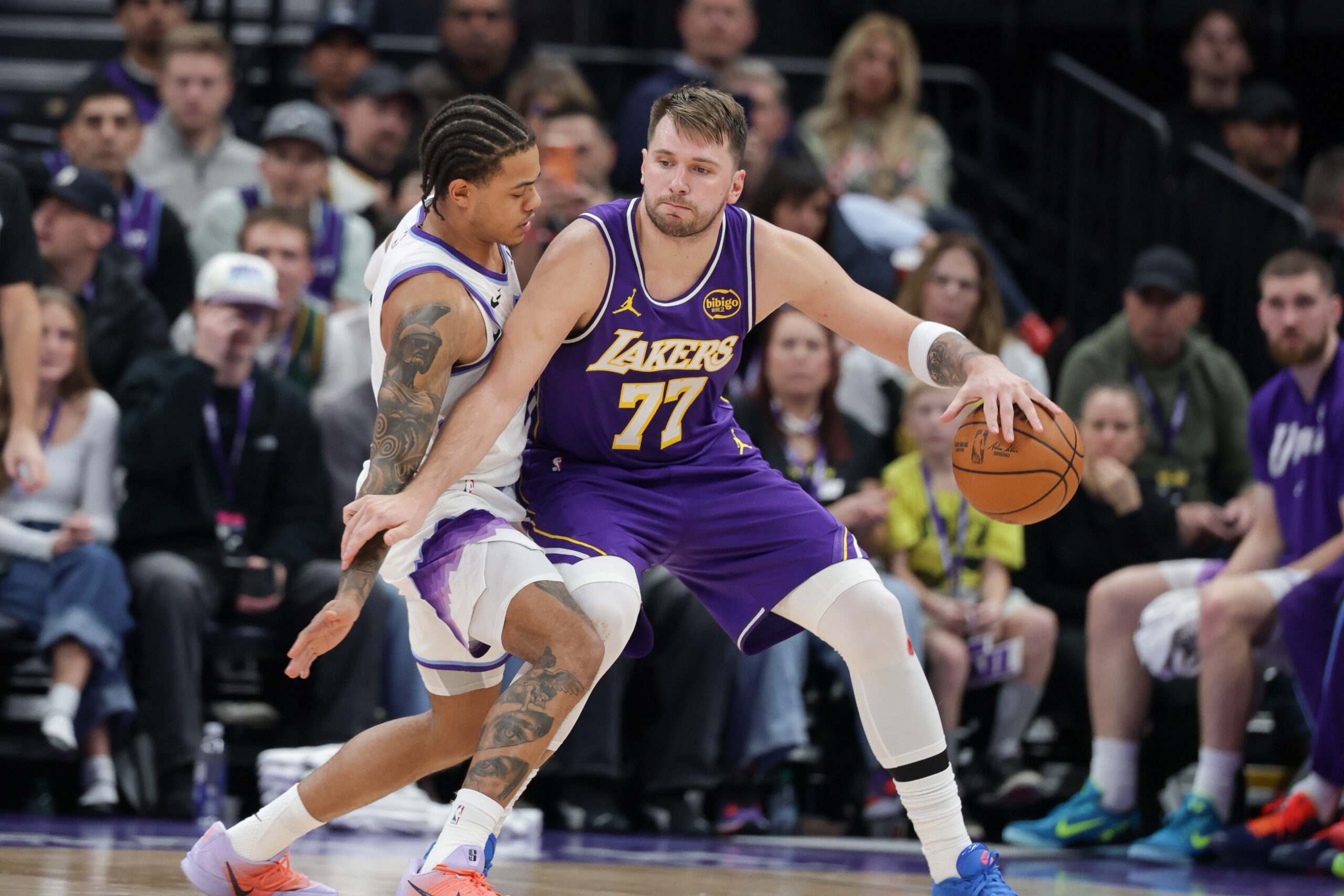 Dec 18, 2025; Salt Lake City, Utah, USA; Los Angeles Lakers forward/guard Luka Doncic (77) tries to keep Utah Jazz guard Keyonte George (3) away from the ball during the second half at Delta Center. Mandatory Credit: Chris Nicoll-Imagn Images