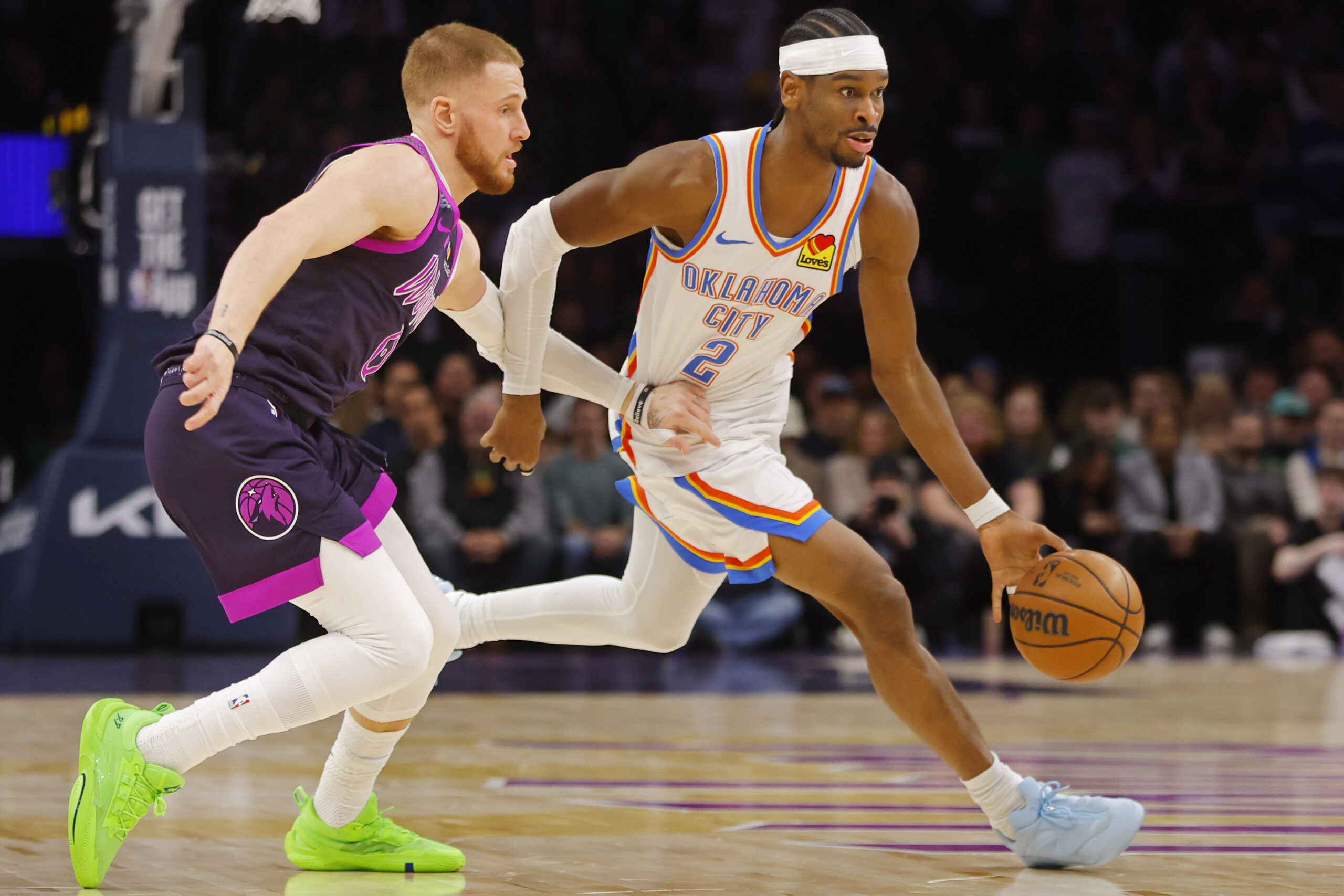 Dec 19, 2025; Minneapolis, Minnesota, USA; Oklahoma City Thunder guard Shai Gilgeous-Alexander (2) works past Minnesota Timberwolves guard Donte DiVincenzo (0) in the first quarter at Target Center. Mandatory Credit: Bruce Kluckhohn-Imagn Images