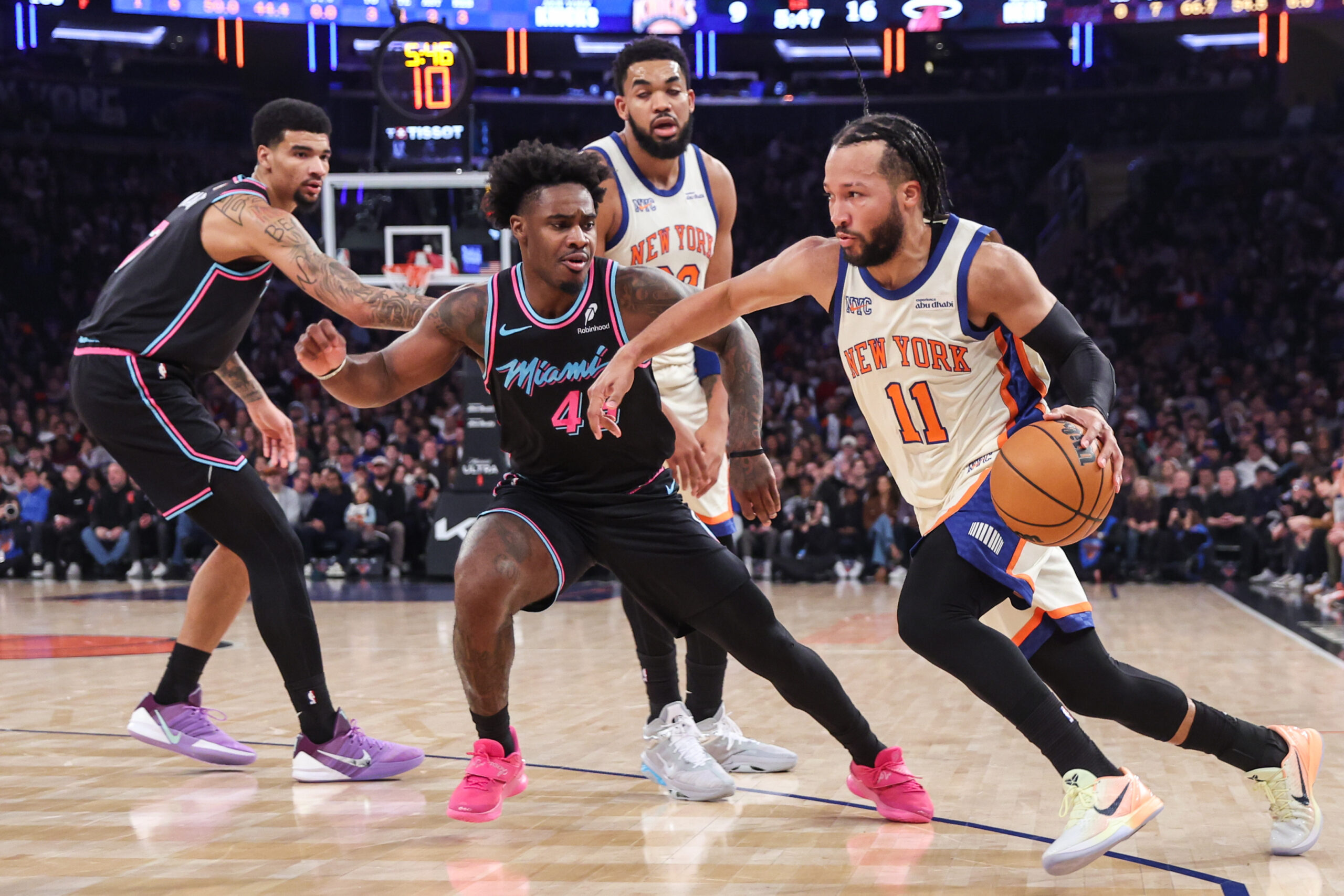 Dec 21, 2025; New York, New York, USA; New York Knicks guard Jalen Brunson (11) drives past Miami Heat guard Davion Mitchell (45) in the first quarter at Madison Square Garden. Mandatory Credit: Wendell Cruz-Imagn Images