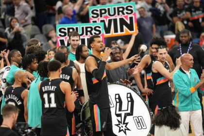 Dec 23, 2025; San Antonio, Texas, USA; San Antonio Spurs forward Victor Wembanyama (1) leads fans on a cheer after a victory over the Oklahoma City Thunder at Frost Bank Center. Mandatory Credit: Scott Wachter-Imagn Images