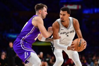 Nov 5, 2025; Los Angeles, California, USA; San Antonio Spurs forward Victor Wembanyama (1) controls the ball against Los Angeles Lakers guard Luka Doncic (77) during the second half at Crypto.com Arena. Mandatory Credit: Gary A. Vasquez-Imagn Images