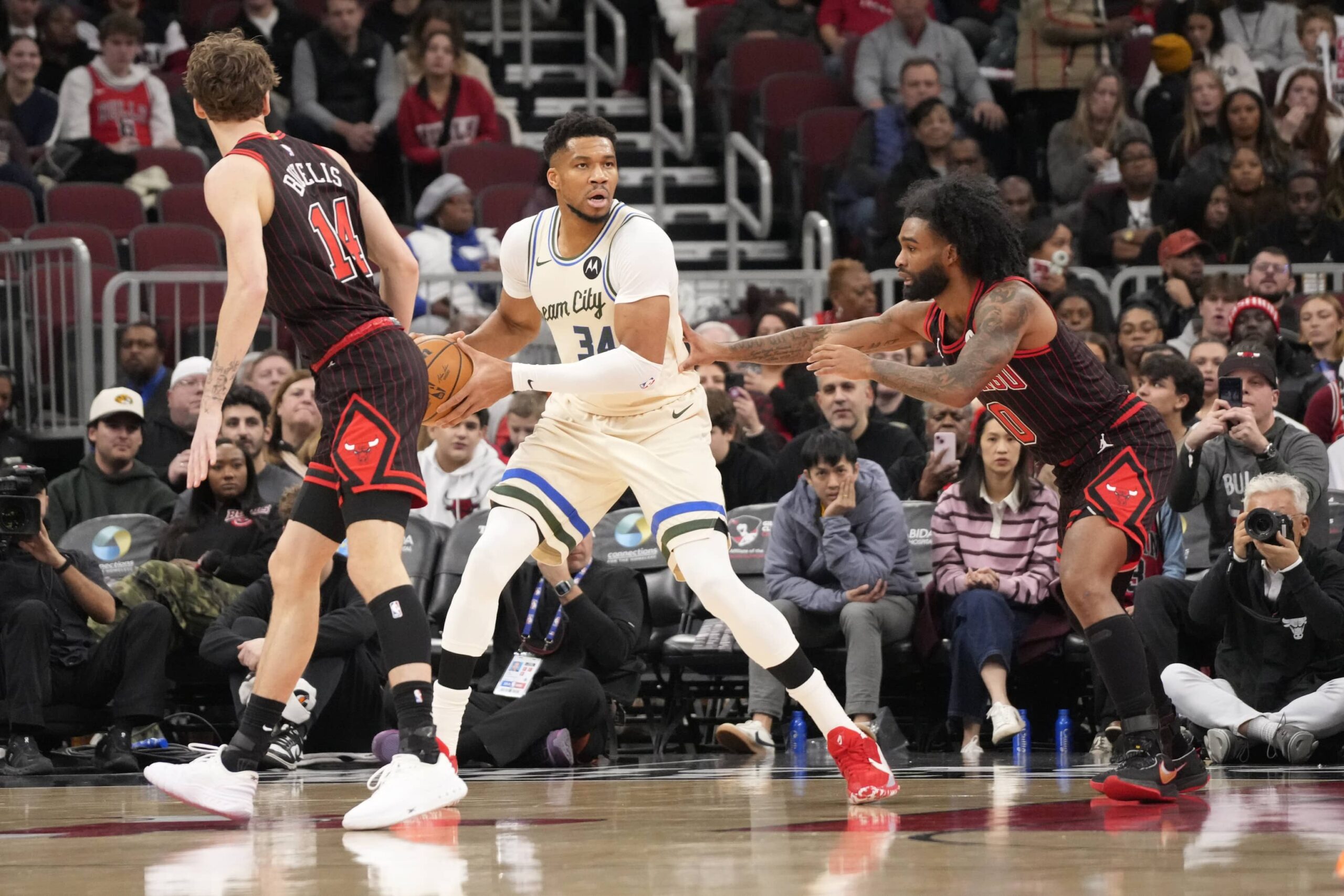 Chicago, Illinois, USA; Chicago Bulls guard Coby White (0) defends Milwaukee Bucks forward Giannis Antetokounmpo (34)during the first half at United Center. Mandatory Credit: David Banks-Imagn Images