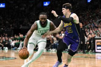 Boston, Massachusetts, USA; Boston Celtics guard Jaylen Brown (7) drives to the basket against Los Angeles Lakers guard Austin Reaves (15) during the fourth quarter at the TD Garden. Mandatory Credit: Brian Fluharty-Imagn Images