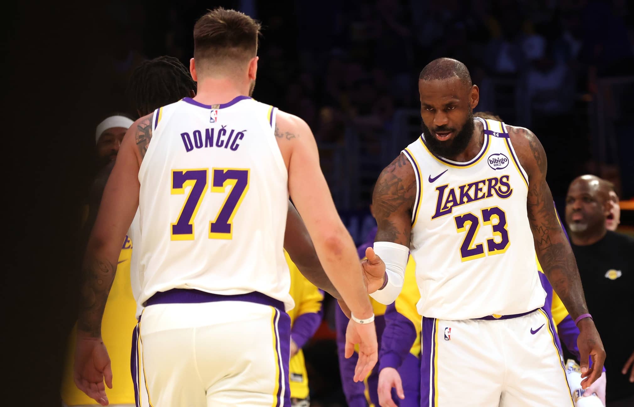 Los Angeles, California, USA; Los Angeles Lakers forward LeBron James (23) and guard Luka Doncic (77) react after a play during the first quarter against the LA Clippers at Crypto.com Arena. Mandatory Credit: Jason Parkhurst-Imagn Images