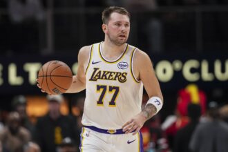 Atlanta, Georgia, USA; Los Angeles Lakers guard Luka Doncic (77) controls the ball against the Atlanta Hawks during the first half at State Farm Arena. Mandatory Credit: Dale Zanine-Imagn Images