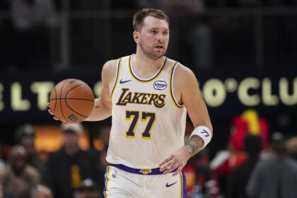 Atlanta, Georgia, USA; Los Angeles Lakers guard Luka Doncic (77) controls the ball against the Atlanta Hawks during the first half at State Farm Arena. Mandatory Credit: Dale Zanine-Imagn Images