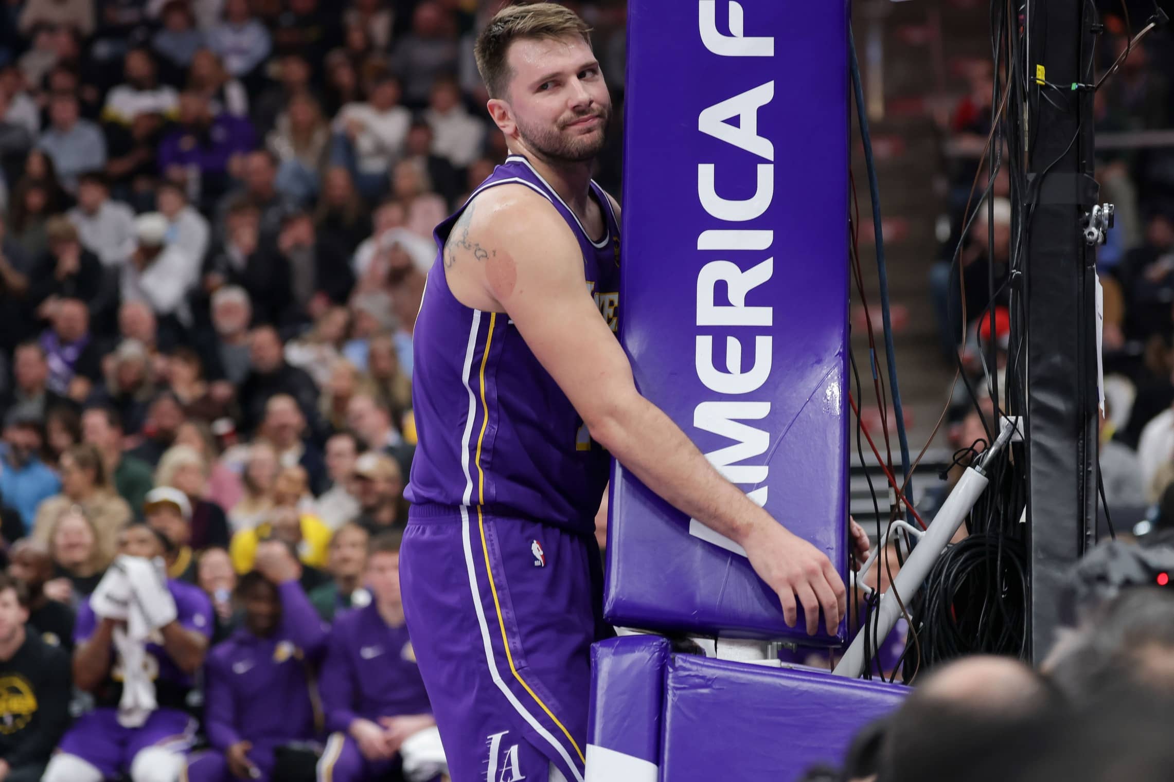 Salt Lake City, Utah, USA; Los Angeles Lakers forward/guard Luka Doncic (77) hugs the stanchion after a foul during the first quarter against the Utah Jazz at Delta Center. Mandatory Credit: Chris Nicoll-Imagn Images