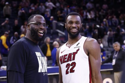 San Francisco, California, USA; Golden State Warriors forward Draymond Green (23) smiles with Miami Heat forward Andrew Wiggins (22) after the game at Chase Center. Mandatory Credit: Kelley L Cox-Imagn Images