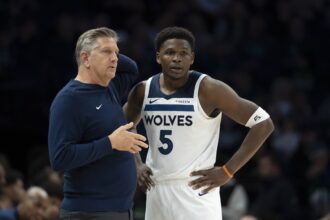 Minneapolis, Minnesota, USA; Minnesota Timberwolves head coach Chris Finch and Minnesota Timberwolves guard Anthony Edwards (5) looks on against the Dallas Mavericks in the second half at Target Center. Mandatory Credit: Jesse Johnson-Imagn Images