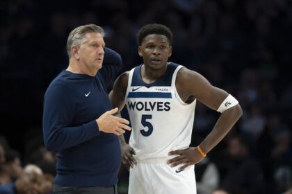 Minneapolis, Minnesota, USA; Minnesota Timberwolves head coach Chris Finch and Minnesota Timberwolves guard Anthony Edwards (5) looks on against the Dallas Mavericks in the second half at Target Center. Mandatory Credit: Jesse Johnson-Imagn Images