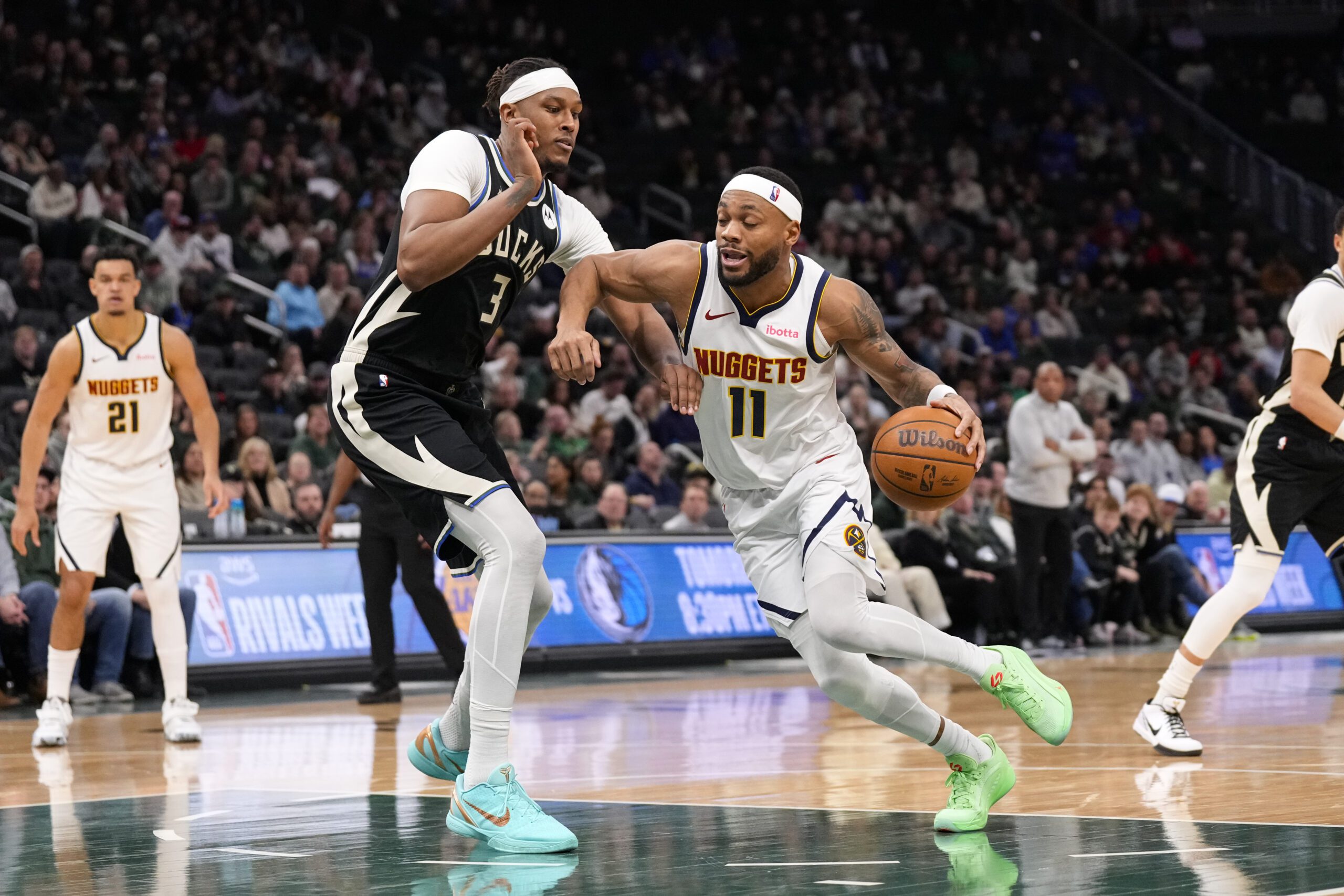 Jan 23, 2026; Milwaukee, Wisconsin, USA; Denver Nuggets guard Bruce Brown (11) drives towards the basket against Milwaukee Bucks center Myles Turner (3) during the fourth quarter at Fiserv Forum. Mandatory Credit: Jeff Hanisch-Imagn Images
