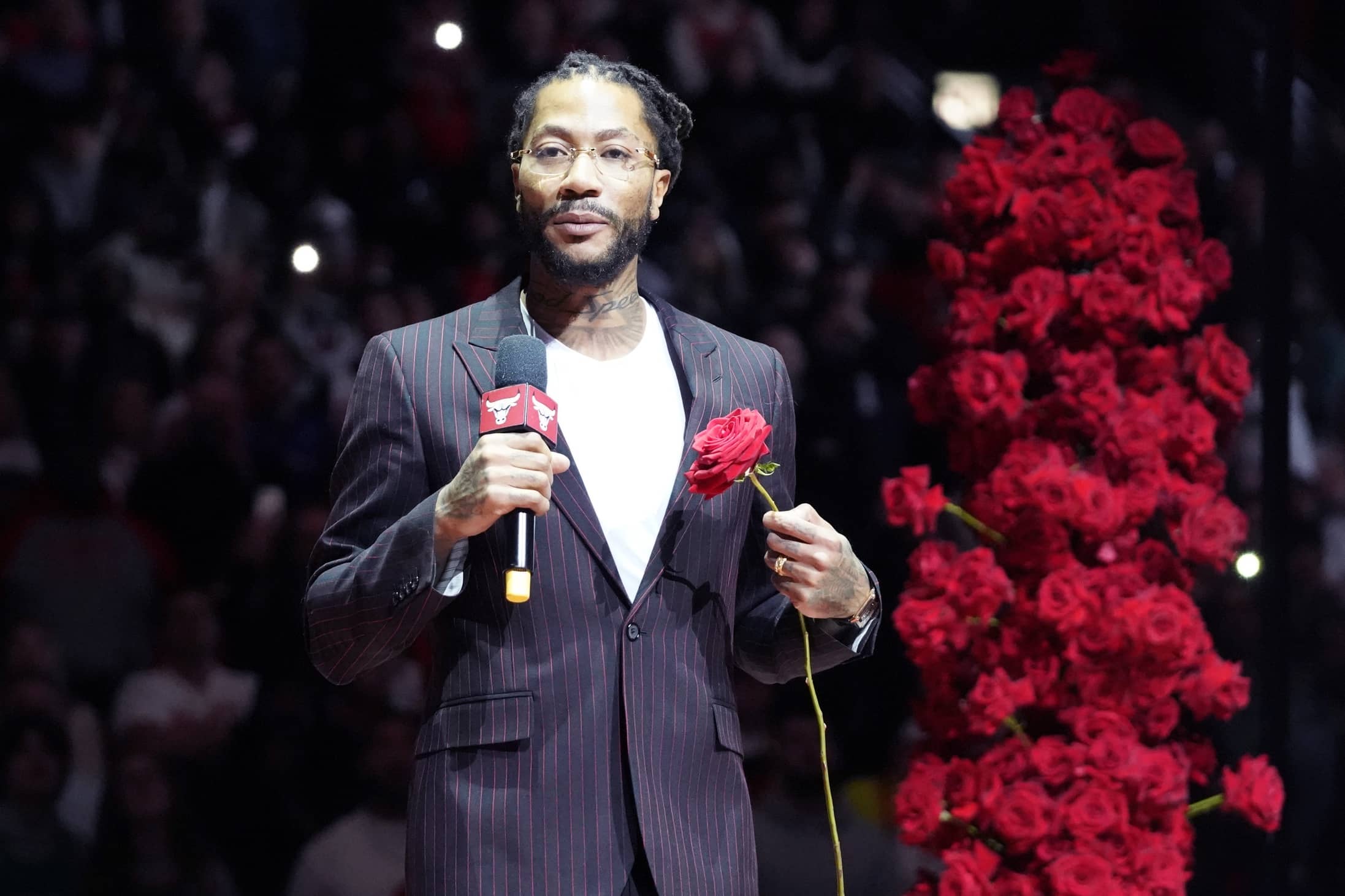 Chicago Bulls and New York Knicks former player Derrick Rose speaks as he is honored at halftime of a game between the Chicago Bulls and the New York Knicks at United Center.