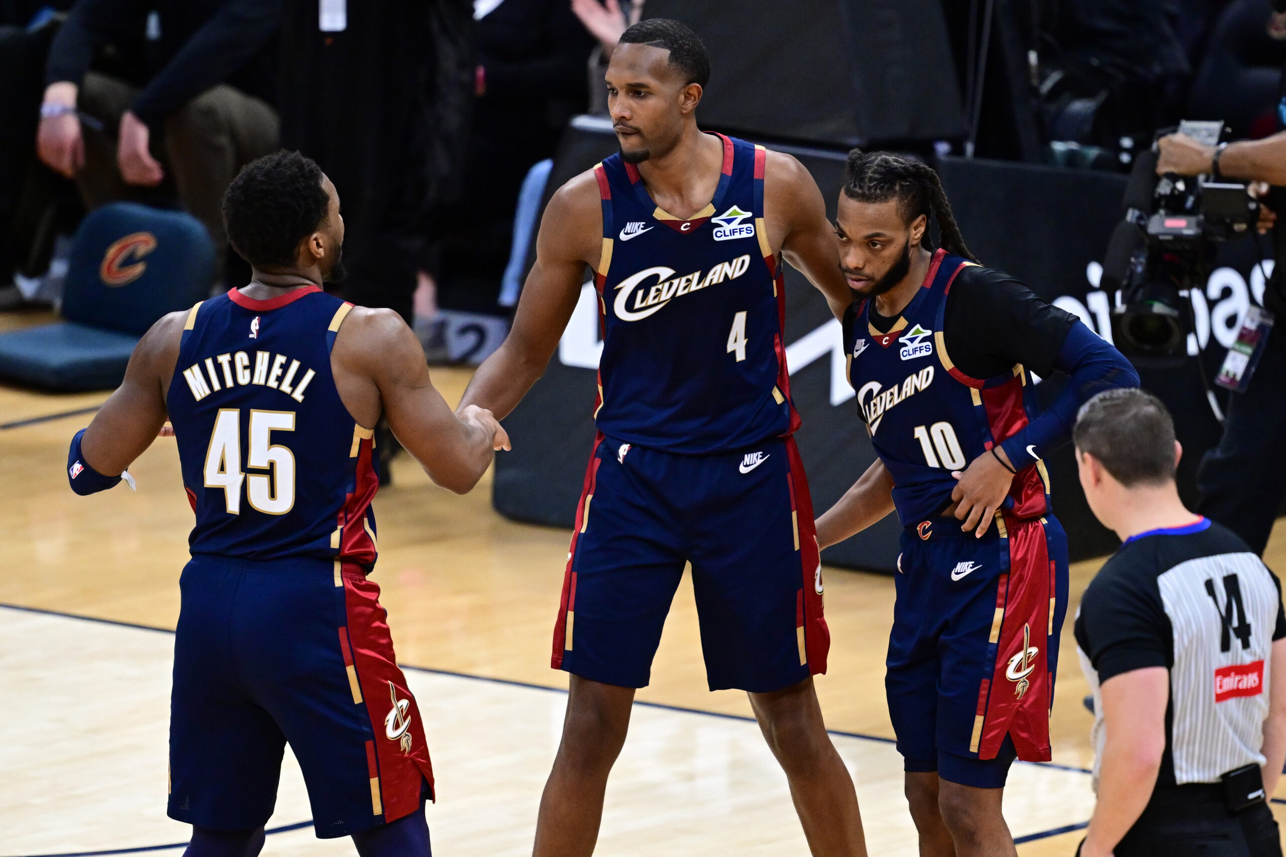 Jan 2, 2026; Cleveland, Ohio, USA; Cleveland Cavaliers center Evan Mobley (4) congratulates guard Donovan Mitchell (45) and guard Darius Garland (10) after the Cavaliers defeated the Denver Nuggets at Rocket Arena. Mandatory Credit: David Dermer-Imagn Images