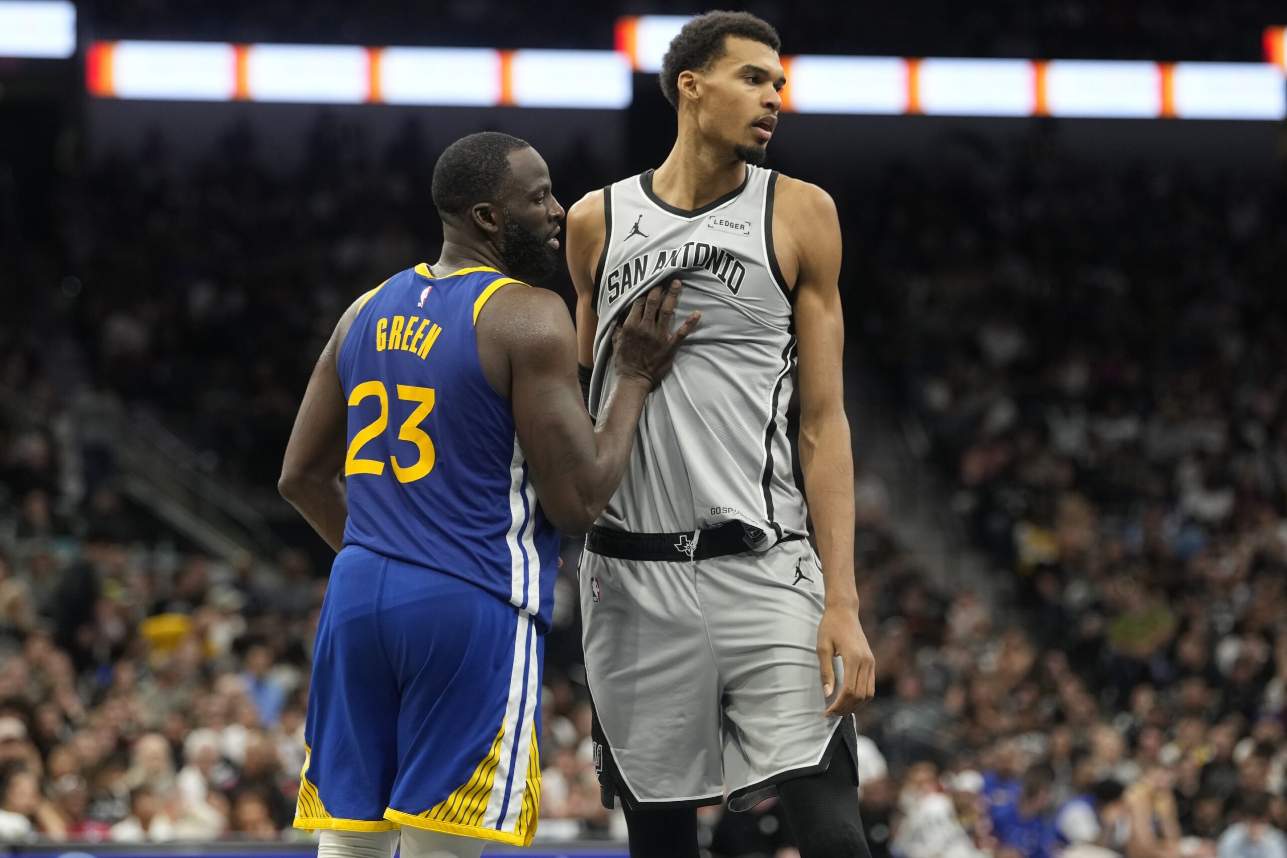 Nov 14, 2025; San Antonio, Texas, USA; San Antonio Spurs forward Victor Wembanyama (1) waits for an inbound pass while defended by Golden State Warriors forward Draymond Green (23) during the second half at Frost Bank Center. Mandatory Credit: Scott Wachter-Imagn Images