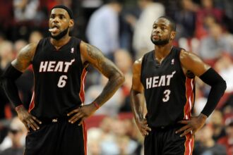 Miami Heat small forward LeBron James (6) and shooting guard Dwyane Wade (3) look on as time winds down in the fourth quarter against the Portland Trail Blazers at the Rose Garden. Heat won the game 107-93.