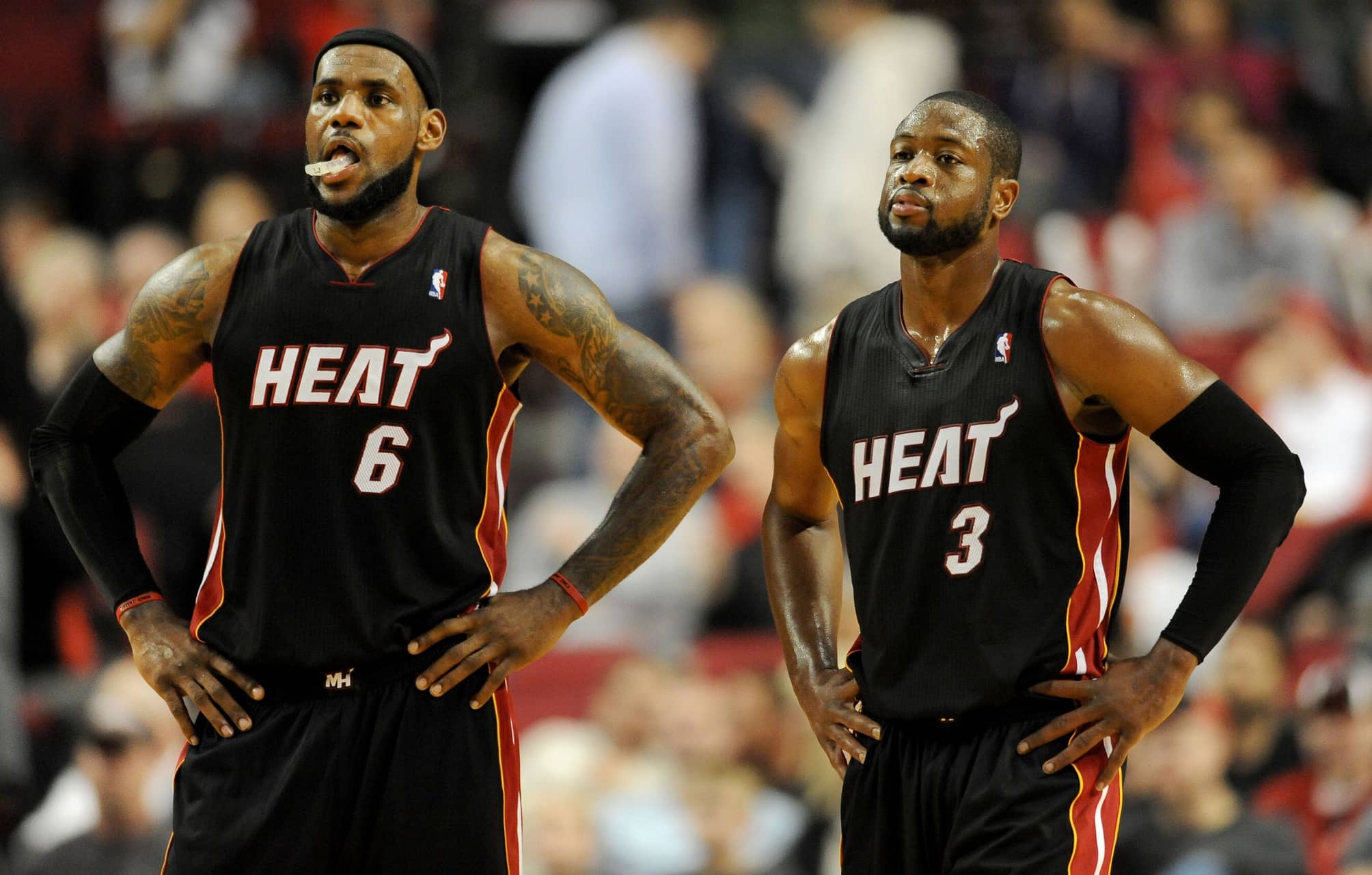 Miami Heat small forward LeBron James (6) and shooting guard Dwyane Wade (3) look on as time winds down in the fourth quarter against the Portland Trail Blazers at the Rose Garden. Heat won the game 107-93.