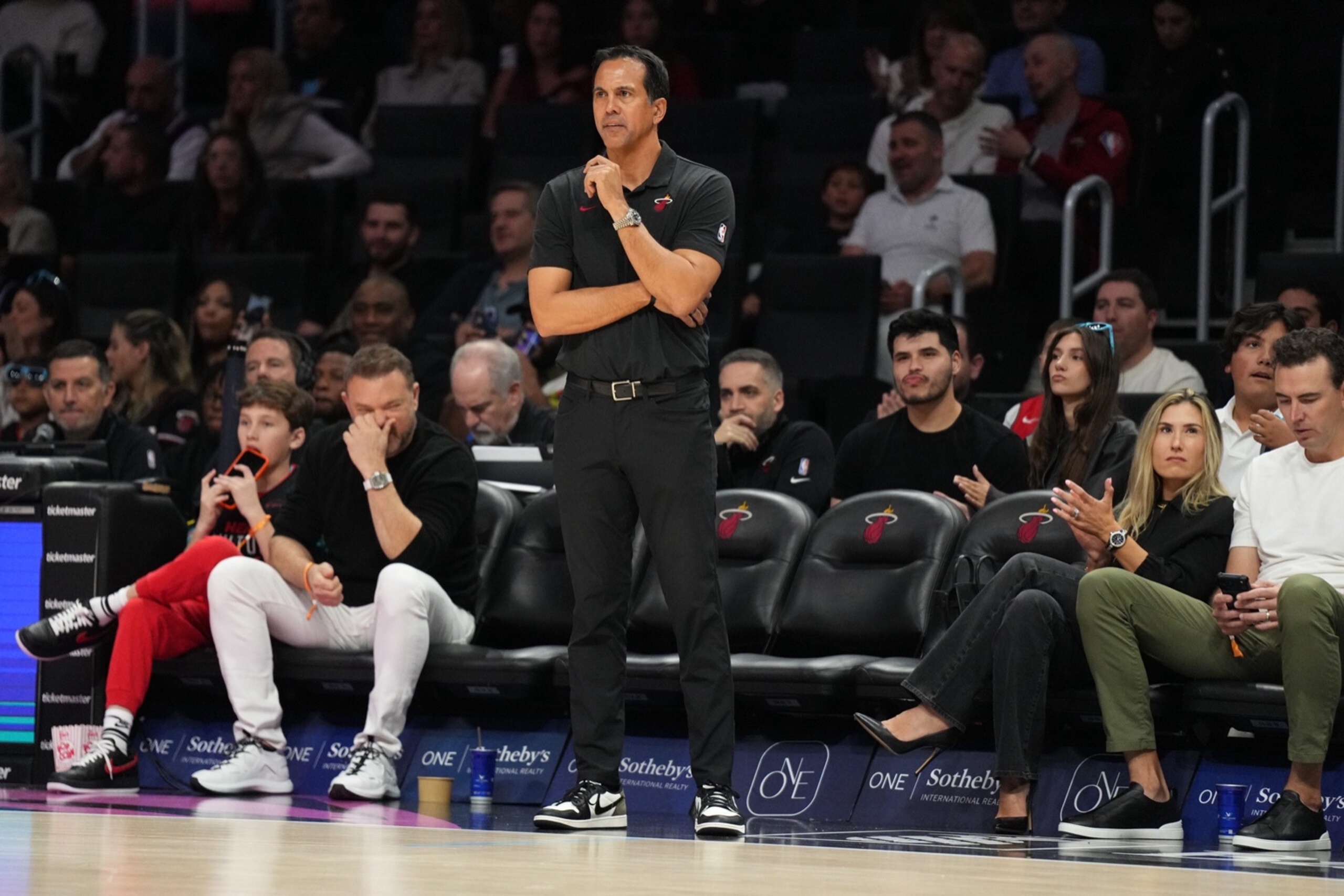 Jan 4, 2026; Miami, Florida, USA; Miami Heat head coach Erik Spoelstra keeps his eyes on his team during the first half at Kaseya Center against the New Orleans Pelicans. Mandatory Credit: Jim Rassol-Imagn Images