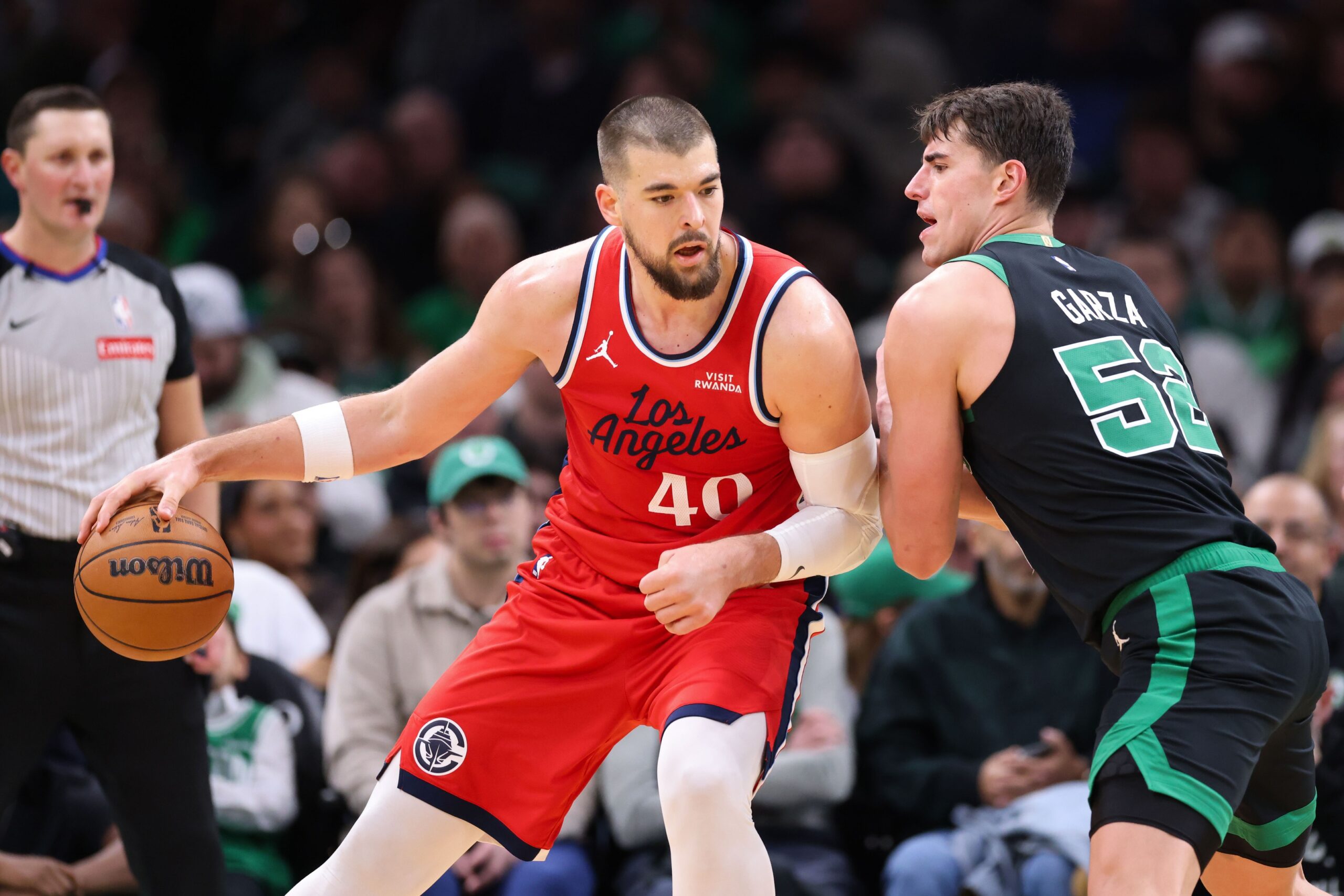 Nov 16, 2025; Boston, Massachusetts, USA; Boston Celtics forward Luka Garza (52) defends Los Angeles Clippers center Ivica Zubac (40) during the first half at TD Garden. Mandatory Credit: Paul Rutherford-Imagn Images