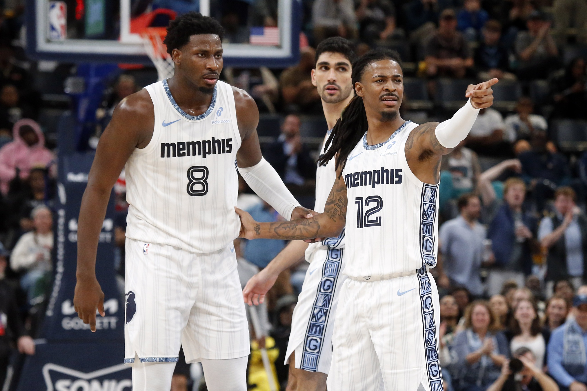Dec 26, 2025; Memphis, Tennessee, USA; Memphis Grizzlies guard Ja Morant (12) reacts with forward/center Jaren Jackson Jr. (8) during the fourth quarter against the Milwaukee Bucks at FedExForum. Mandatory Credit: Petre Thomas-Imagn Images