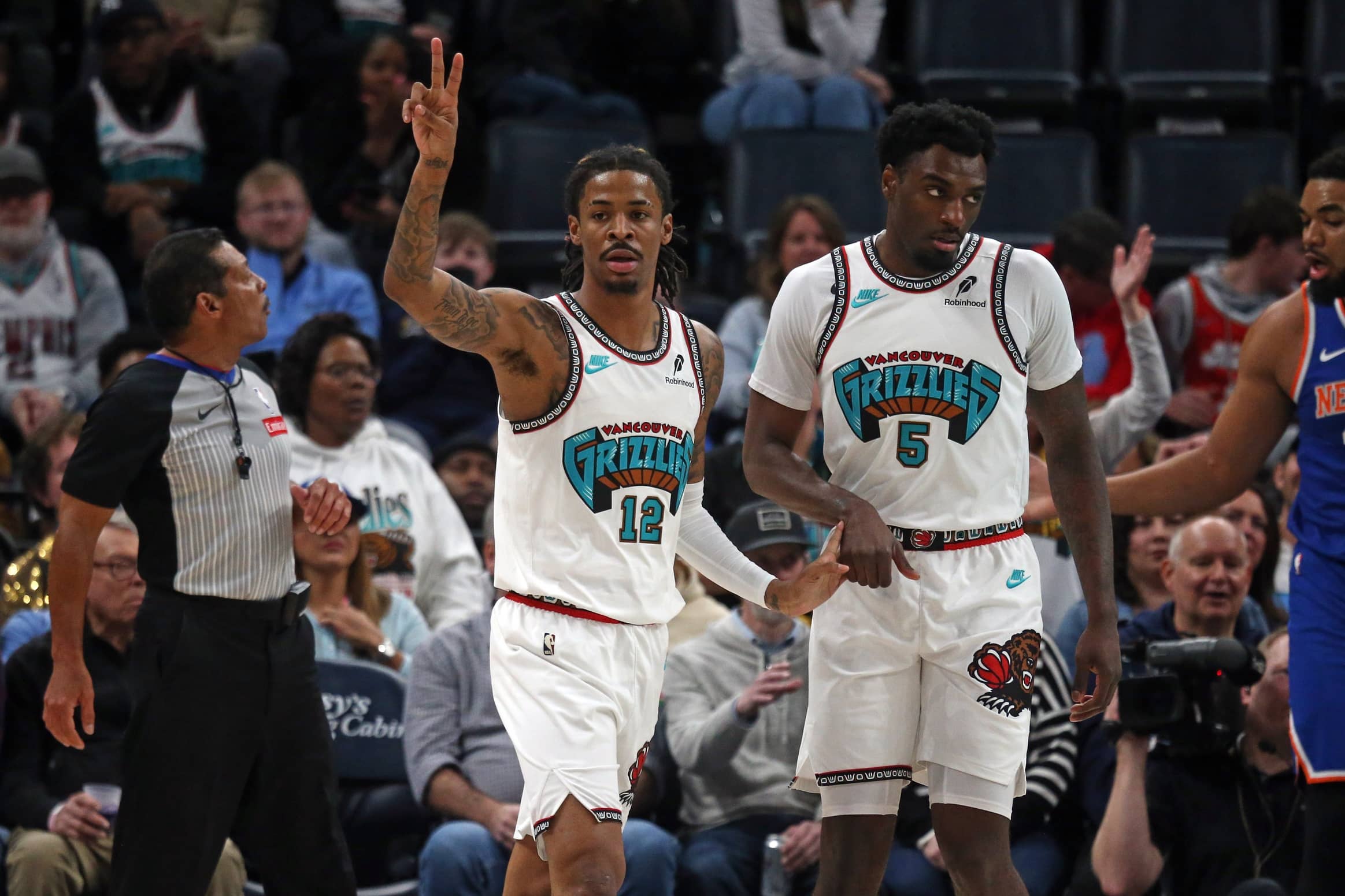 Feb 28, 2025; Memphis, Tennessee, USA; Memphis Grizzlies guard Ja Morant (12) reacts with guard Vince Williams Jr. (5) during the first quarter against the New York Knicks at FedExForum. Mandatory Credit: Petre Thomas-Imagn Images