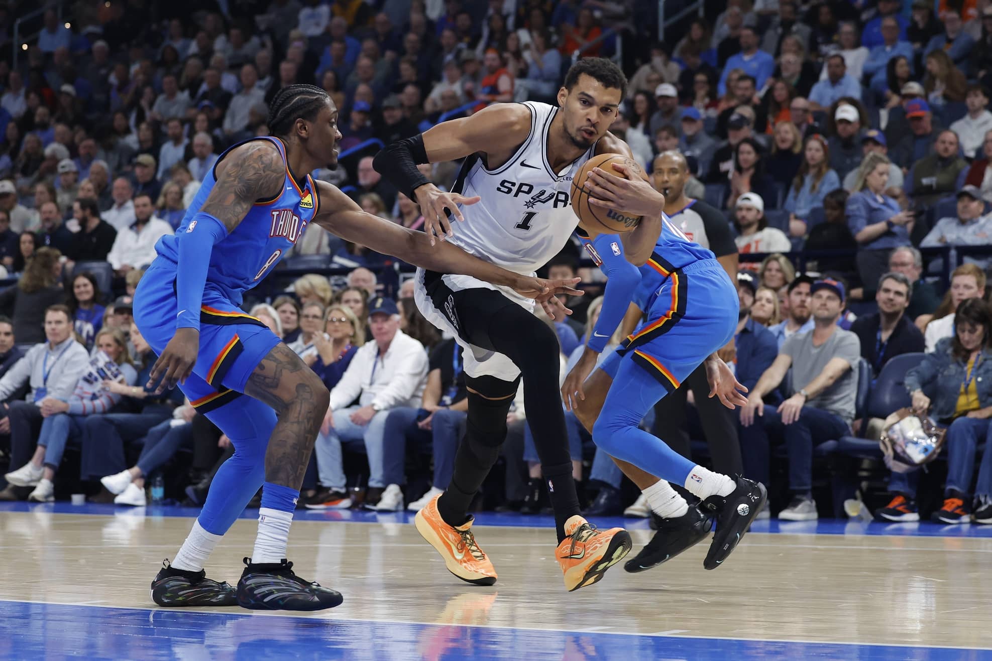 Jan 13, 2026; Oklahoma City, Oklahoma, USA; San Antonio Spurs forward/center Victor Wembanyama (1) drives to the basket beside Oklahoma City Thunder guard/forward Jalen Williams (8) during the second quarter at Paycom Center. Mandatory Credit: Alonzo Adams-Imagn Images