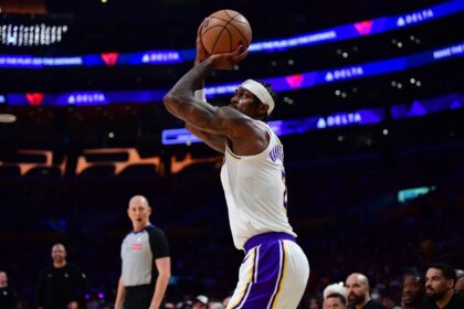 Dec 25, 2025; Los Angeles, California, USA; Los Angeles Lakers forward Jarred Vanderbilt (2) shoots three point basket against the Houston Rockets during the first half at Crypto.com Arena. Mandatory Credit: Gary A. Vasquez-Imagn Images