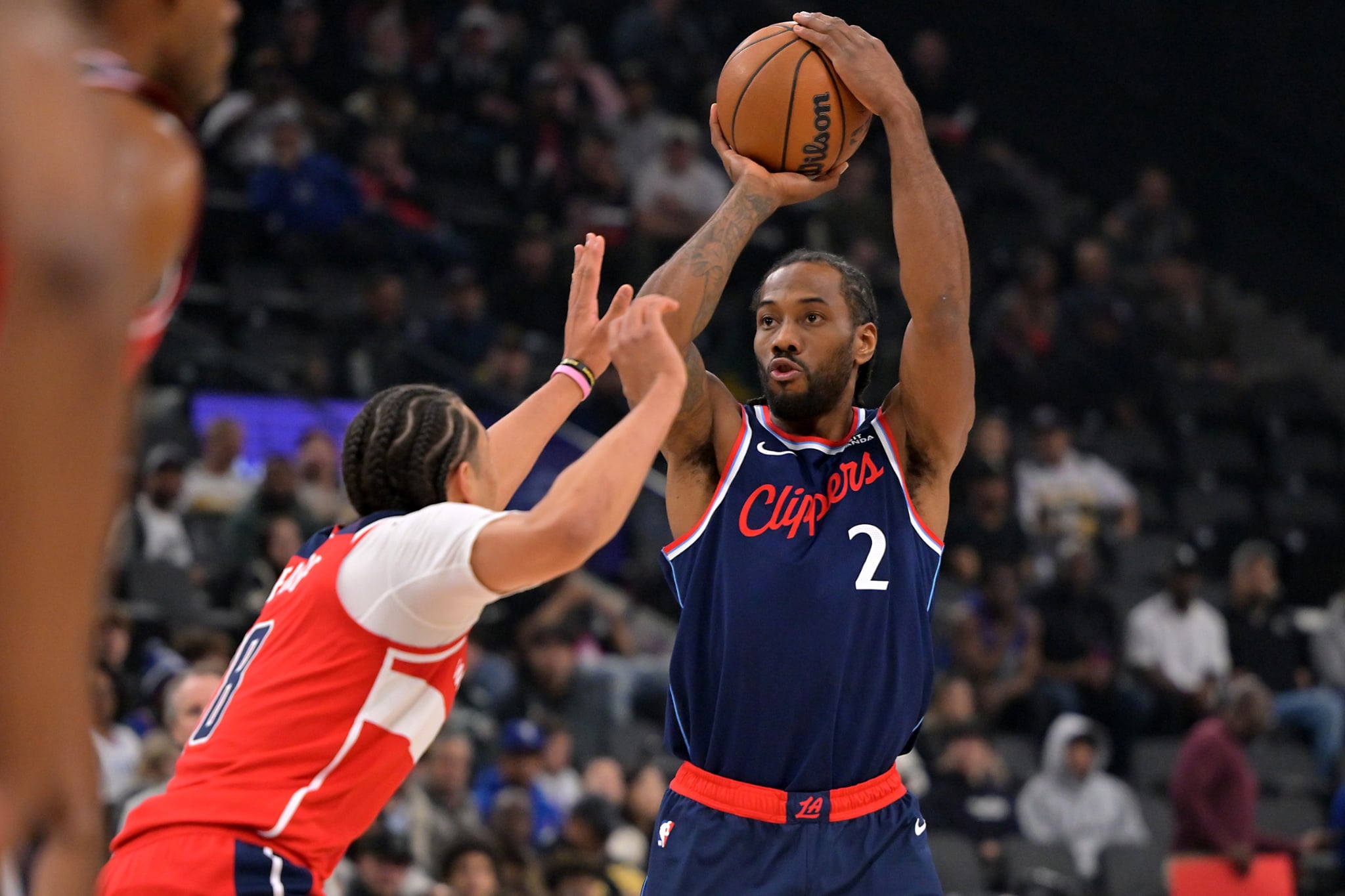 Jan 14, 2026; Inglewood, California, USA; Los Angeles Clippers forward Kawhi Leonard (2) shoots over Washington Wizards forward Kyshawn George (18) in the first half at Intuit Dome. Mandatory Credit: Jayne Kamin-Oncea-Imagn Images