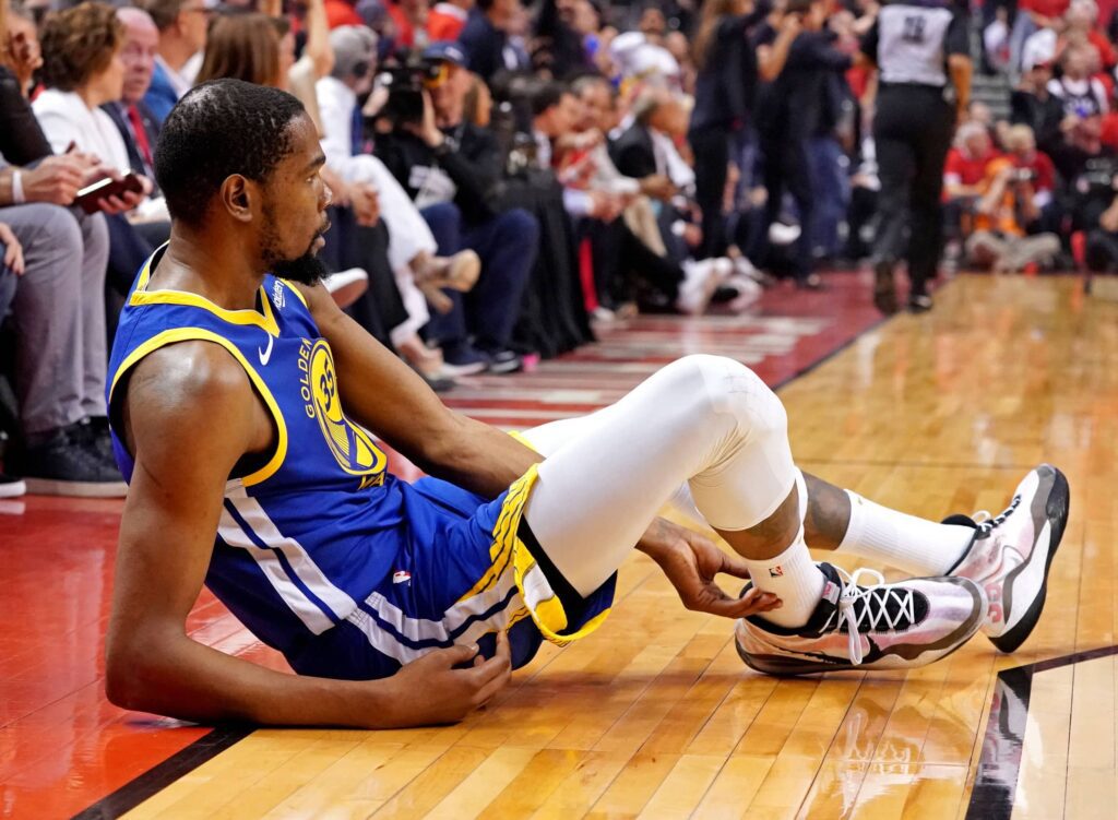Golden State Warriors forward Kevin Durant (35) sits on the court after an apparent injury during the second quarter in game five against the Toronto Raptors of the 2019 NBA Finals at Scotiabank Arena.