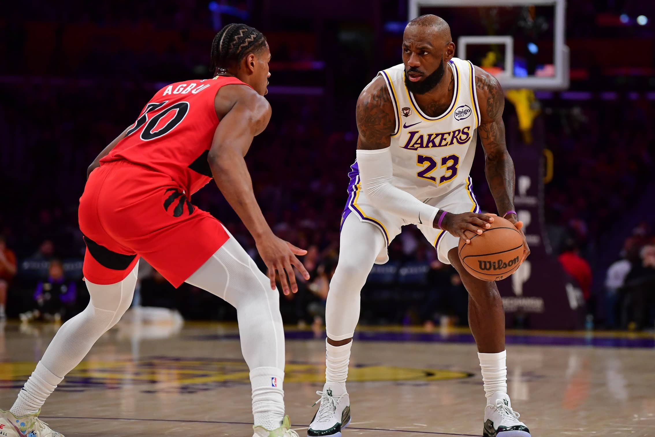 Los Angeles Lakers forward LeBron James (23) controls the ball against Toronto Raptors guard Ochai Agbaji (30) during the first half at Crypto.com Arena.