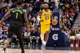 Jan 6, 2026; New Orleans, Louisiana, USA; Los Angeles Lakers forward LeBron James (23) brings the ball up court against New Orleans Pelicans forward Zion Williamson (1) during the first half at Smoothie King Center. Mandatory Credit: Stephen Lew-Imagn Images