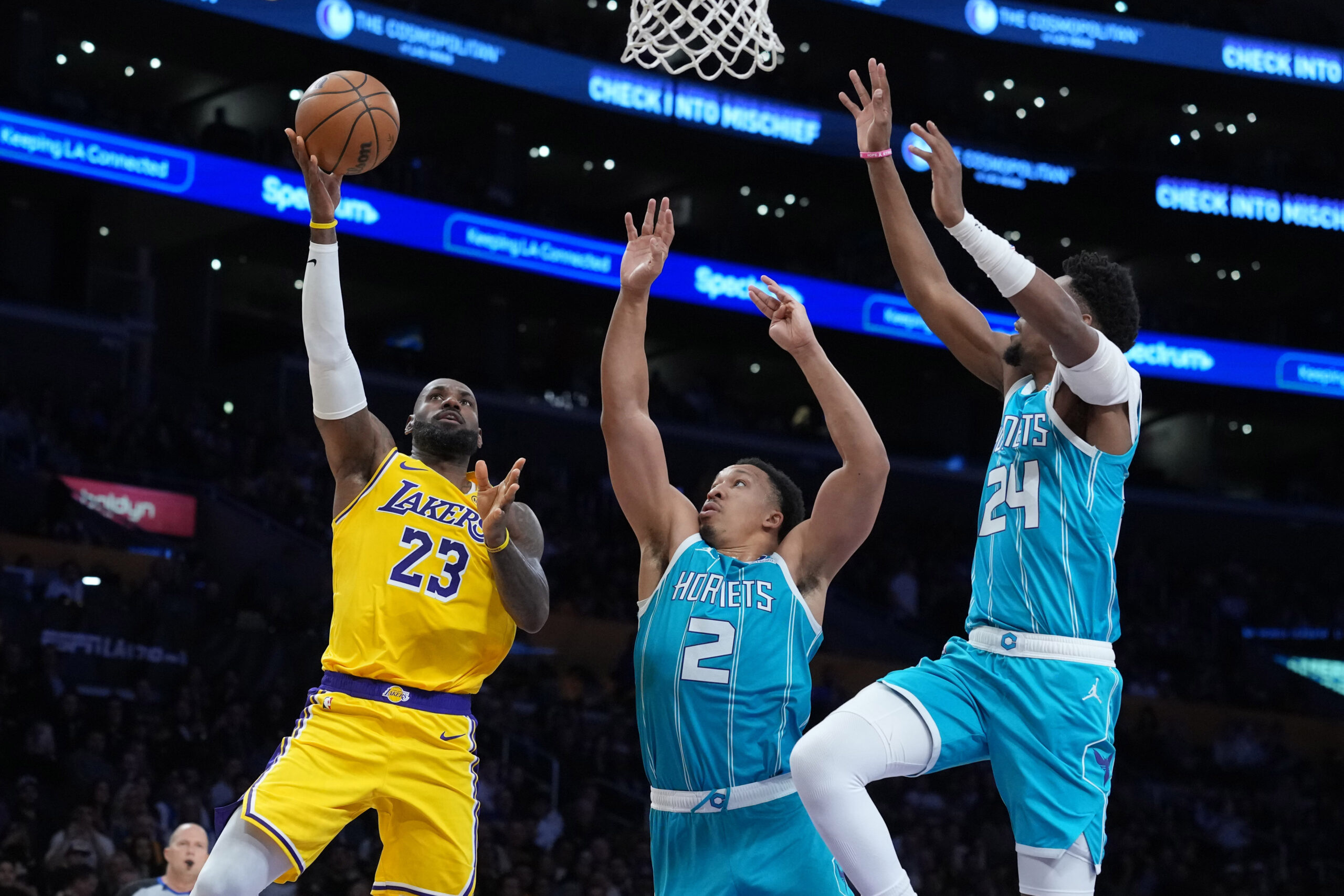 Jan 15, 2026; Los Angeles, California, USA; Los Angeles Lakers forward LeBron James (23) shoots the ball against Charlotte Hornets forward Grant Williams (2) and forward Brandon Miller (24) in the first half at Crypto.com Arena. Mandatory Credit: Kirby Lee-Imagn Images
