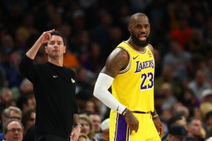 Dec 23, 2025; Phoenix, Arizona, USA; Los Angeles Lakers forward LeBron James (23) and head coach JJ Redick against the Phoenix Suns in the first half at Mortgage Matchup Center. Mandatory Credit: Mark J. Rebilas-Imagn Images