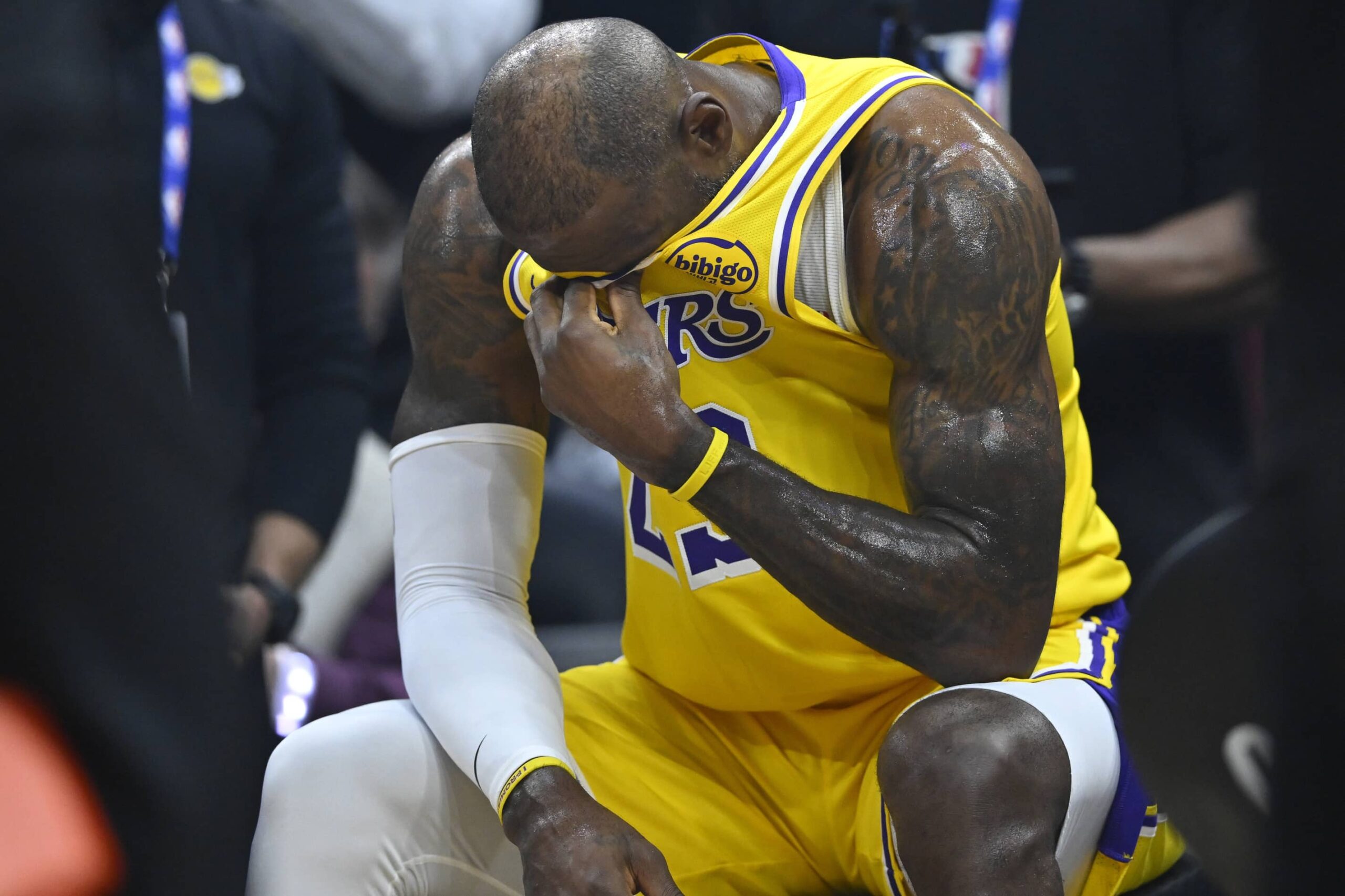 Jan 28, 2026; Cleveland, Ohio, USA; Los Angeles Lakers forward LeBron James (23) reacts on the bench during a video tribute shown on the scoreboard during a timeout in the first quarter against the Cleveland Cavaliers at Rocket Arena. Mandatory Credit: David Richard-Imagn Images