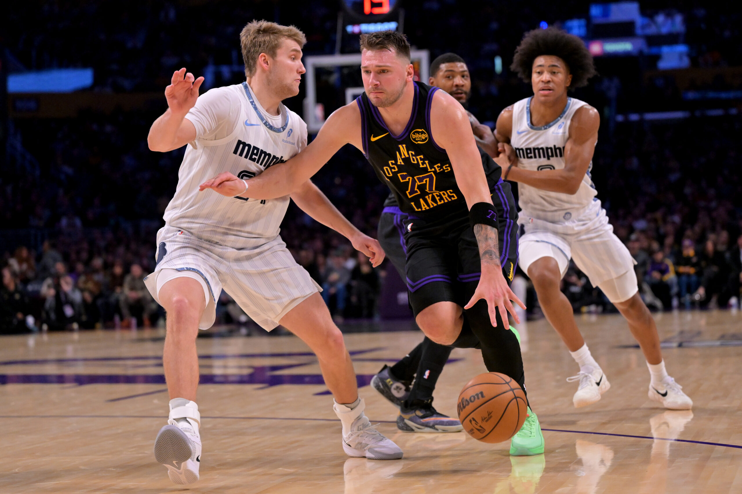Jan 4, 2026; Los Angeles, California, USA; Los Angeles Lakers forward/guard Luka Doncic (77) shoots the ball over Memphis Grizzlies forward Jaylen Wells (0) during the first quarter at Crypto.com Arena. Mandatory Credit: Kiyoshi Mio-Imagn Images