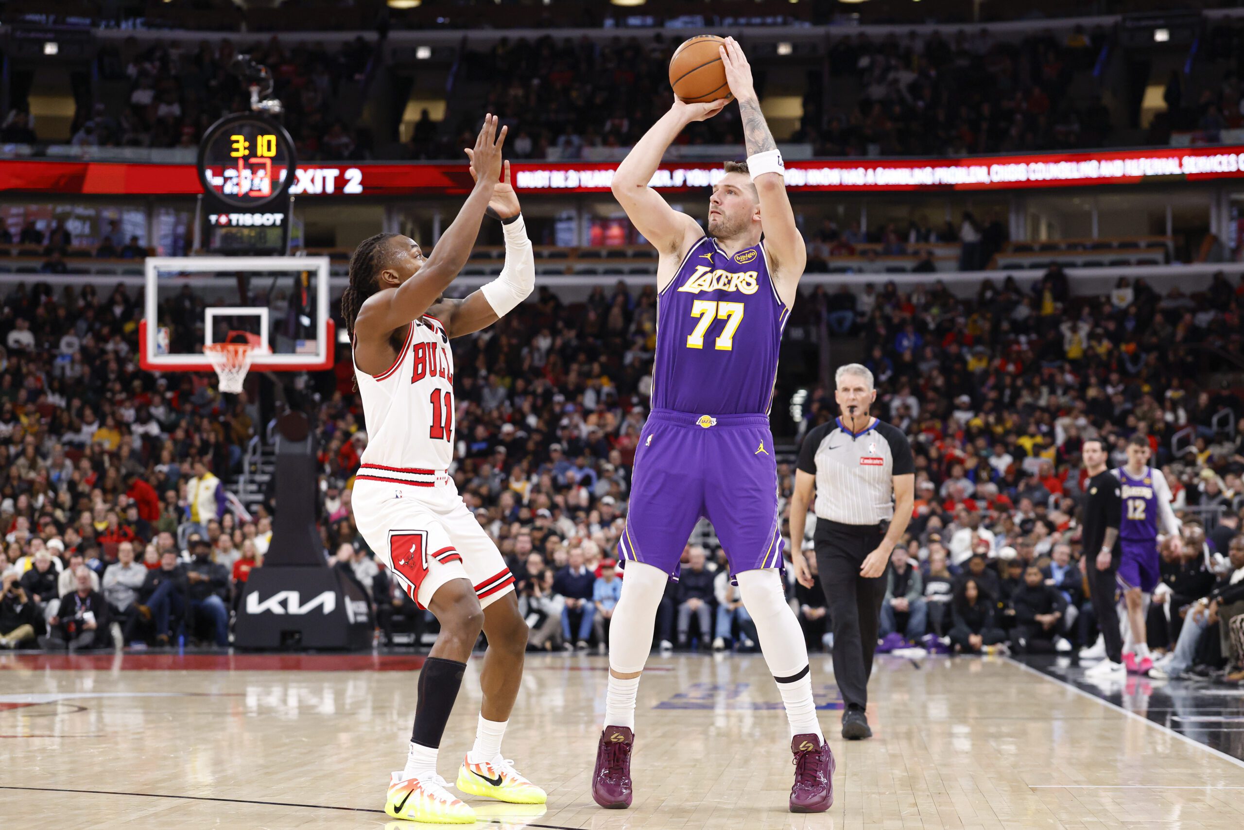 Jan 26, 2026; Chicago, Illinois, USA; Los Angeles Lakers guard Luka Doncic (77) shoots against Chicago Bulls guard Ayo Dosunmu (11) during the second half at United Center. Mandatory Credit: Kamil Krzaczynski-Imagn Images