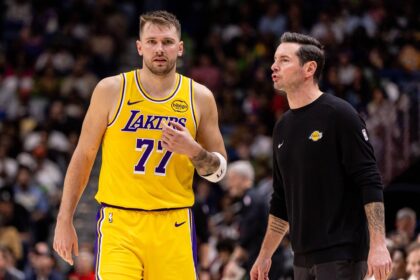 New Orleans, Louisiana, USA; Los Angeles Lakers forward/guard Luka Doncic (77) talks to Head Coach JJ Redick against the New Orleans Pelicans during the second half at Smoothie King Center. Mandatory Credit: Stephen Lew-Imagn Images