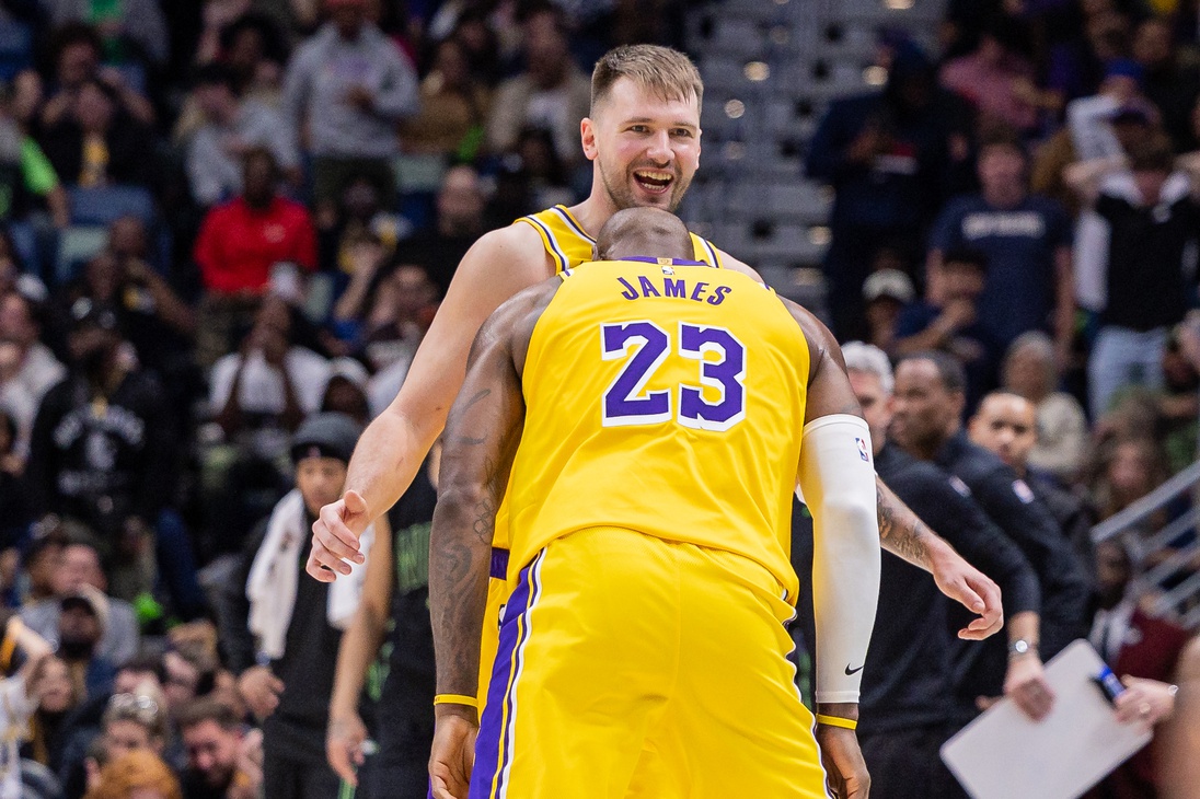 Jan 6, 2026; New Orleans, Louisiana, USA; Los Angeles Lakers forward LeBron James (23) jokes with forward/guard Luka Doncic (77) after a shot against the New Orleans Pelicans during the second half at Smoothie King Center. Mandatory Credit: Stephen Lew-Imagn Images
